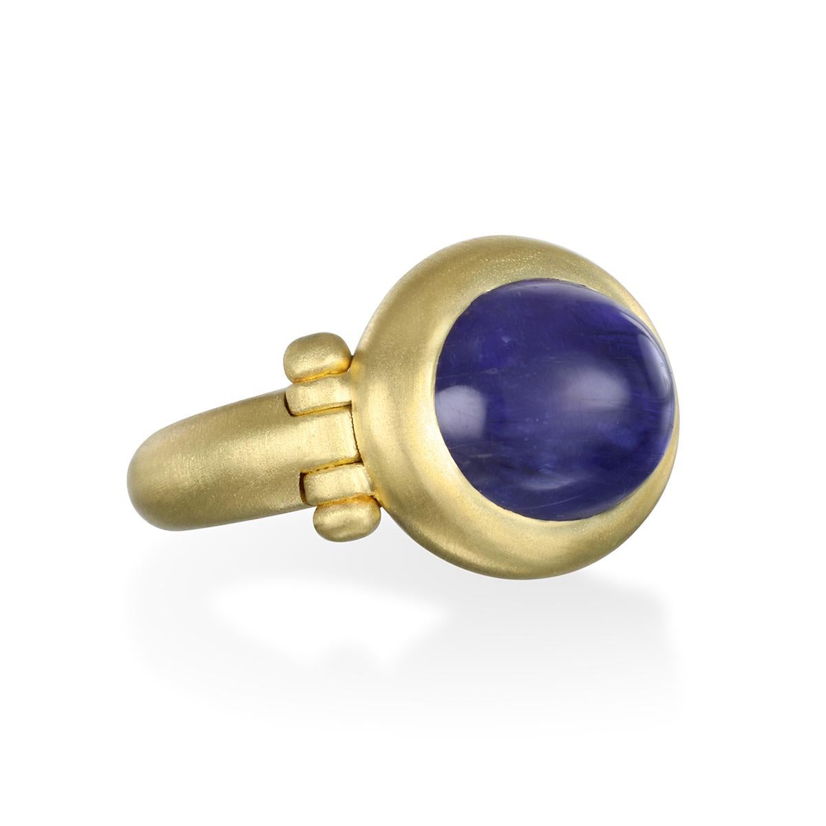 Faye Kim's 18 Karat Gold Tanzanite Cabochon Hinge Ring, with its intriguing blue-violet hue, is beautifully bezel set and matte finished. 

Tanzanite Cabochon 8 Carats
Size 7.25, can be resized

Made in the USA

