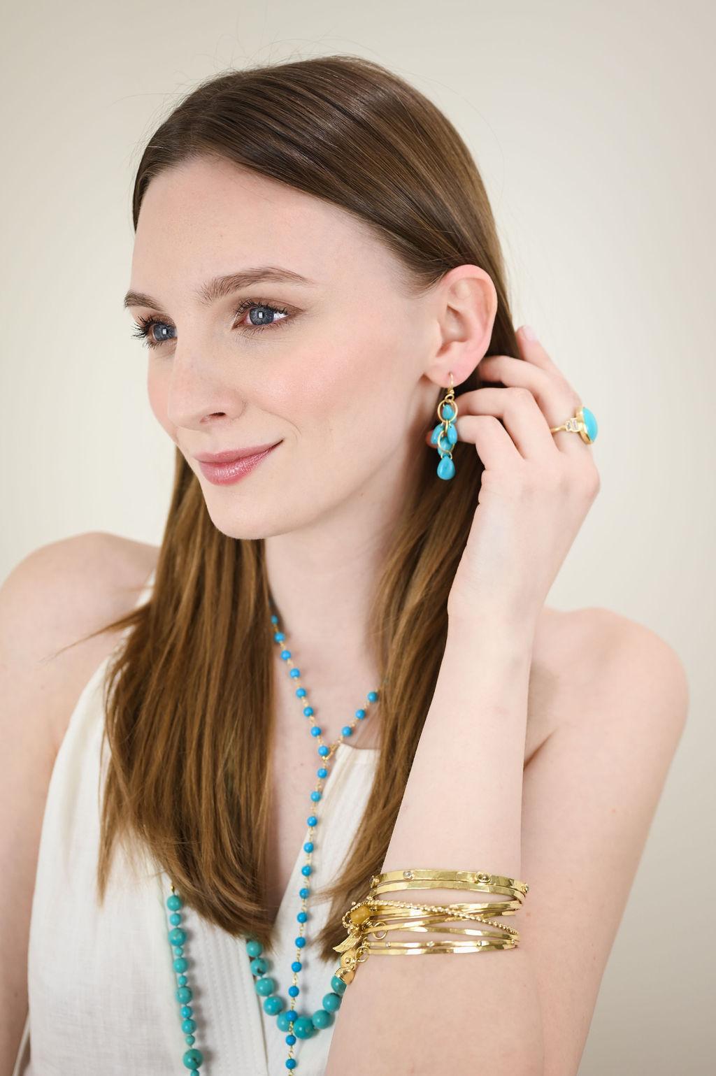 Handwrapped in 18 karat gold*, Faye Kim's Turquoise Lariat Necklace can be adjusted to be worn at various lengths, making it the perfect complement to any outfit. The stones' striking hue pops beautifully against black, white, or virtually any other