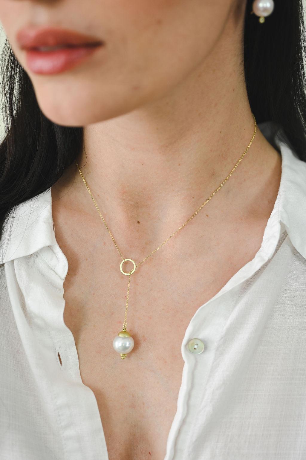 Faye Kim's 18 Karat Gold custom handcrafted White Freshwater Pearl Y Necklace, with its 18 Karat Gold Cap and Gold Triple Granulation tip, offers an effortless, timeless style, perfect for everyday wear or special occasions. Great for layering with