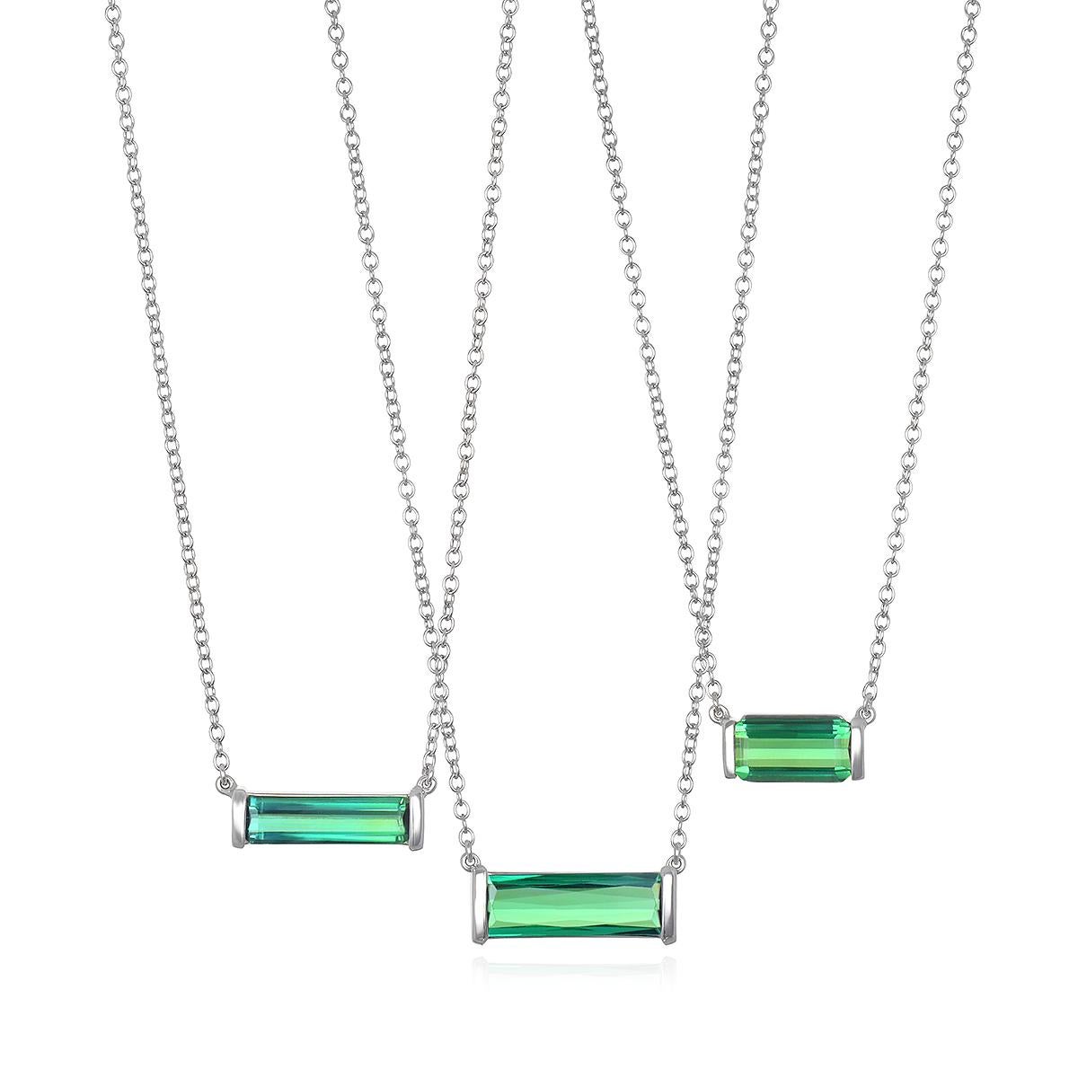 Faye Kim's 18 Karat White Gold Bar Set Green Tourmaline Necklace features a striking, vibrantly-hued gemstone set in a matte white gold finish; certain to add sparkle to any wardrobe and can be worn alone or layered with other necklaces. 

Green