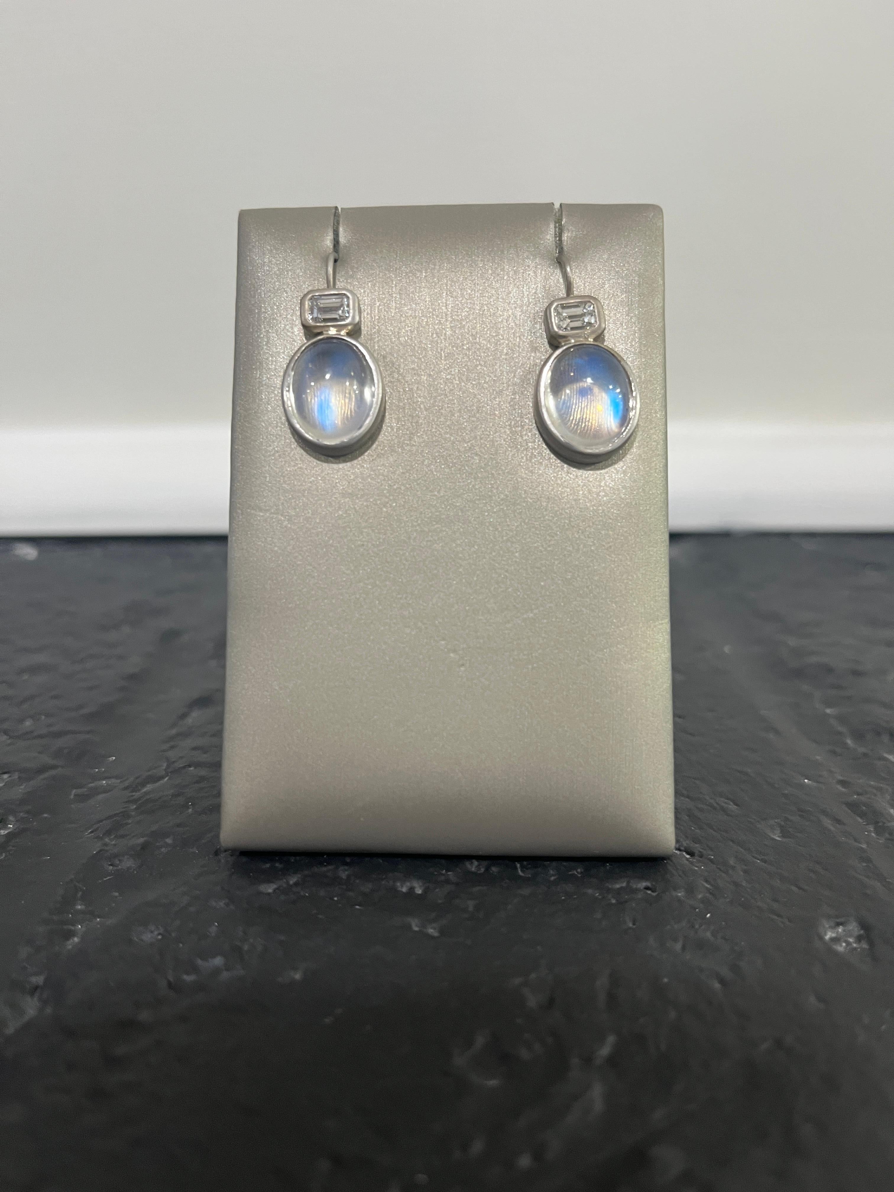 Faye Kim's 18 Karat White Gold Ceylon Moonstone Diamond Earrings feature matched luminscent moonstones; this gemstone is said to resemble moonlight shining through a bed of clouds. The matte white gold finish enhances the moonstones' striking