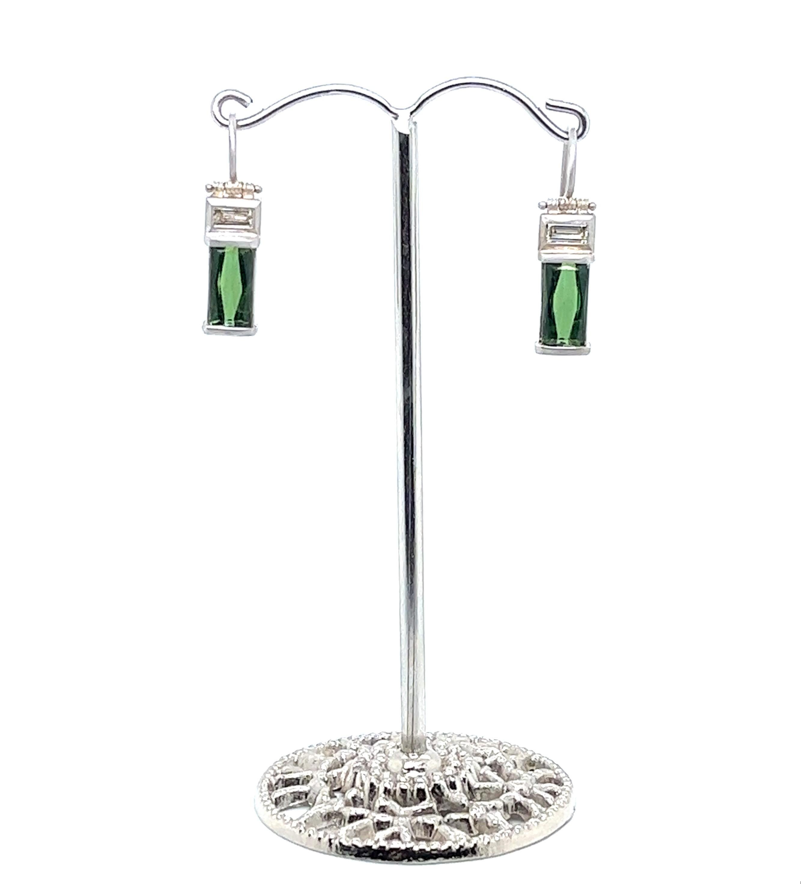 Faye Kim's one-of-a-kind 18 Karat White Gold Diamond Tourmaline Baguette Earrings are finished with hinged ear wires. The bright and beautiful twin green tourmalines paired with white diamonds evoke an Art Deco feel, yet pop against the white gold