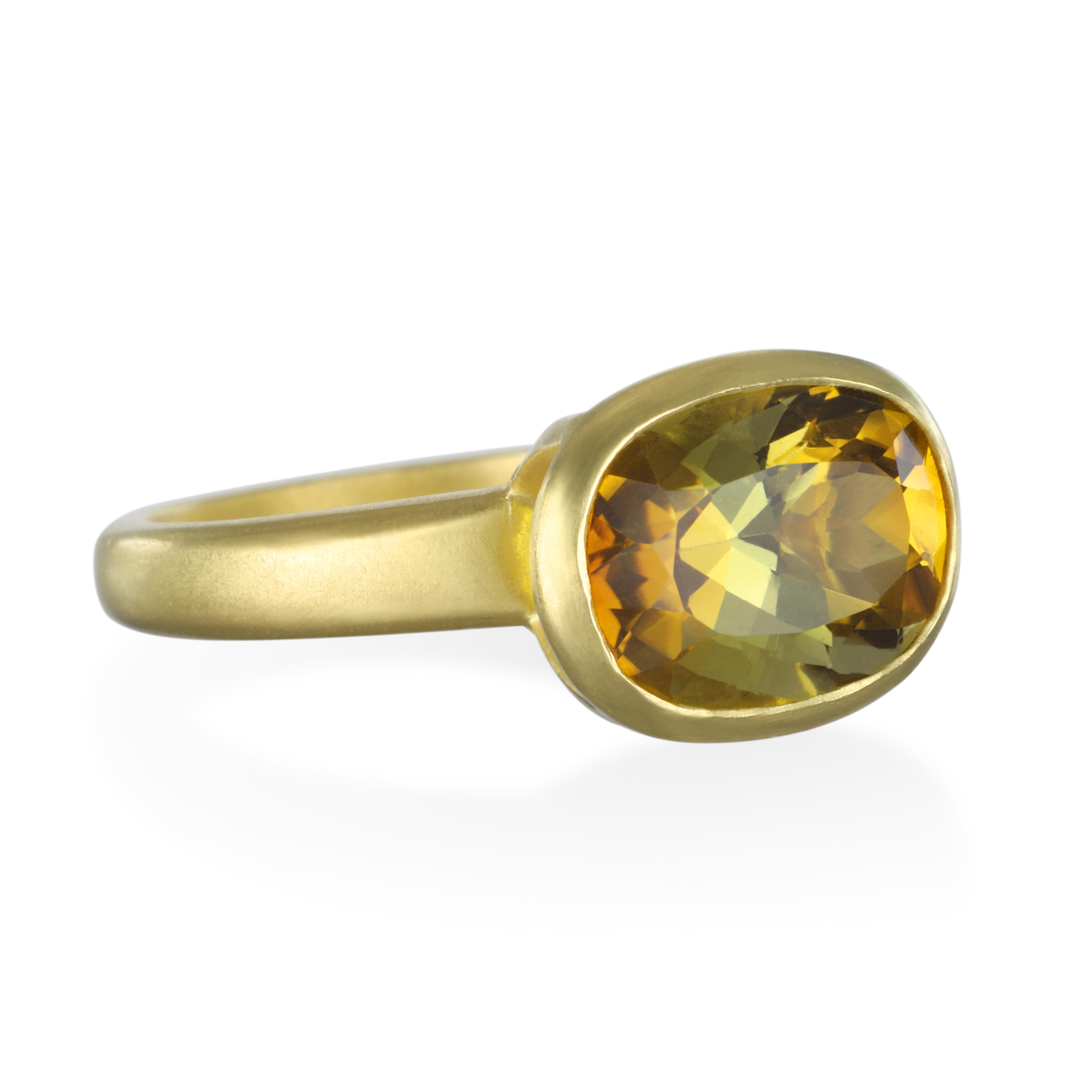 Cushion Cut Yellow-Olive Tourmaline Ring.
The translucent olive-green color of this stylish tourmaline ring mesmerizes and makes a statement all on its own. Its rich hue is not only elegant, but serves to embody all of the textures and colors