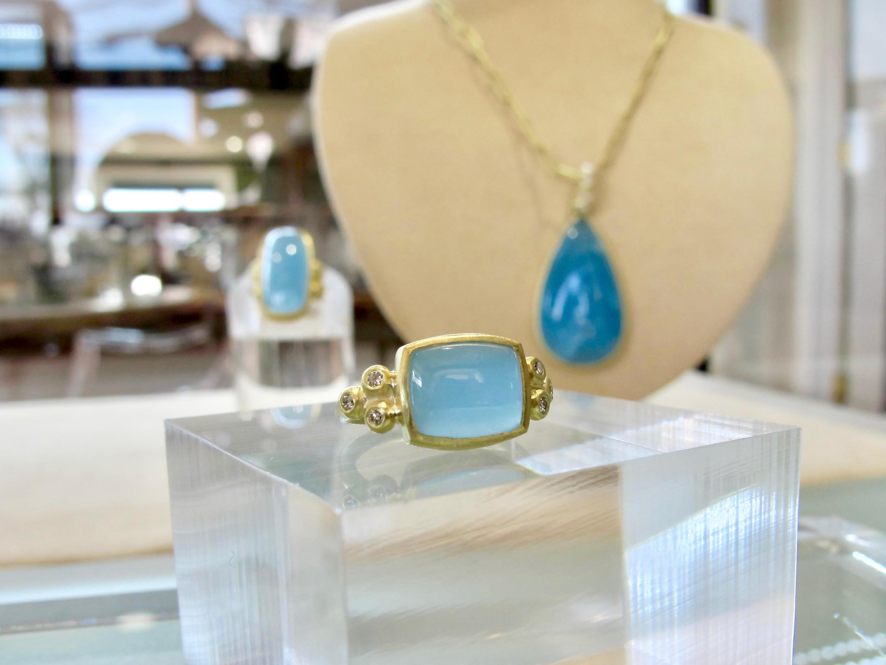 Faye Kim Milky Aquamarine cabochon and diamond ring.  Expertly set in 18k gold.  Refined contemporary style, featuring a cushion-cut milky aquamarine and white brilliant-cut diamonds on each side for a touch of sparkle.
Ring size - 5.25
Milky