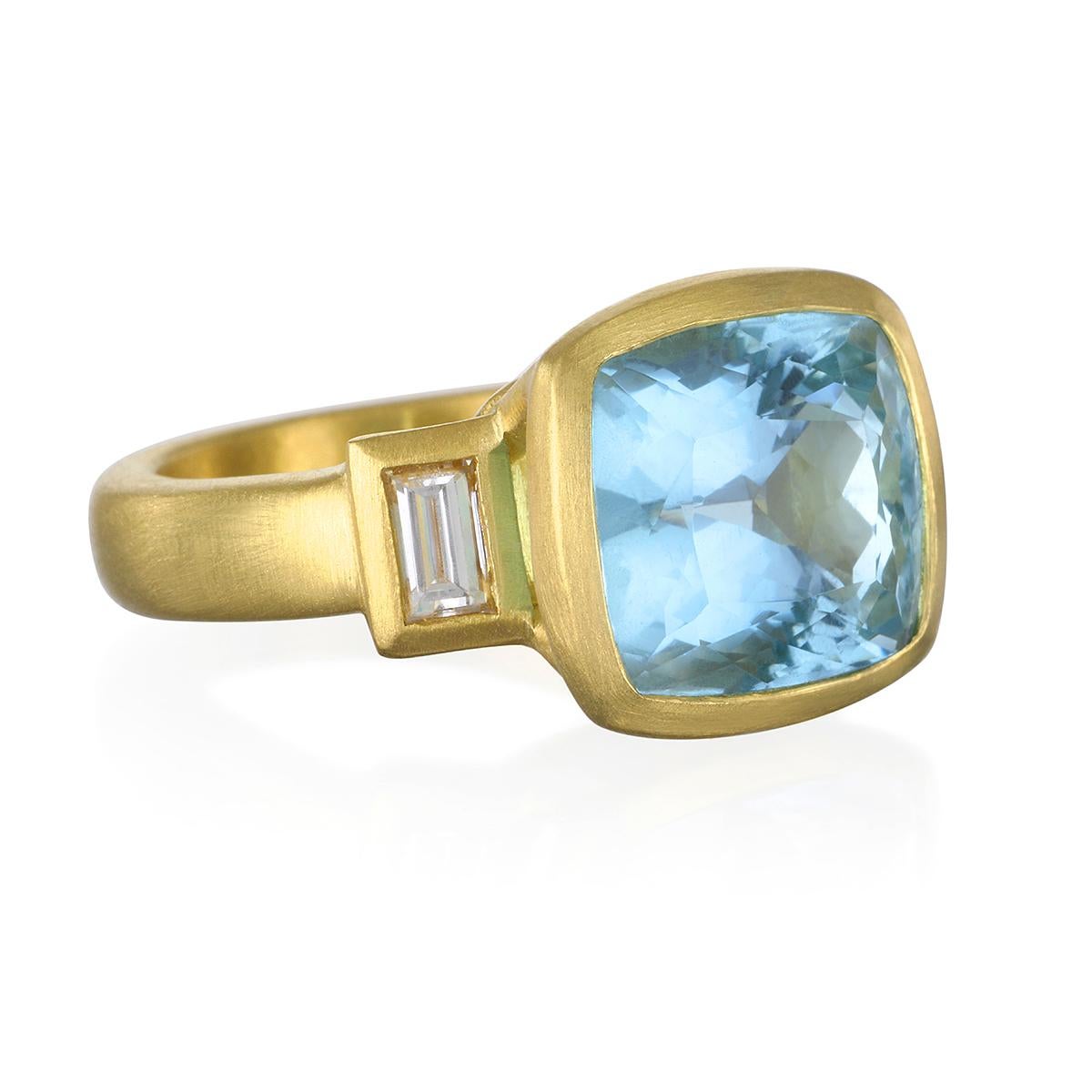 Classic Beauty!
Faye Kim's  18K Gold Aquamarine and Diamond Three Stone Ring is the modern-day cocktail ring that can be worn casually or dressy.
Slightly oversized for impact but with sophisticated subtlety,  the combination of the soft blue