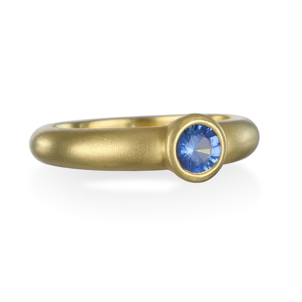 Beauty in simplicity exemplified in Faye Kim's 18k gold blue sapphire bezel ring.
Bright blue round sapphire is bezel set and matte finished for a contemporary style; wear alone or stack with other rings to create your own unique style.

Sapphire: 