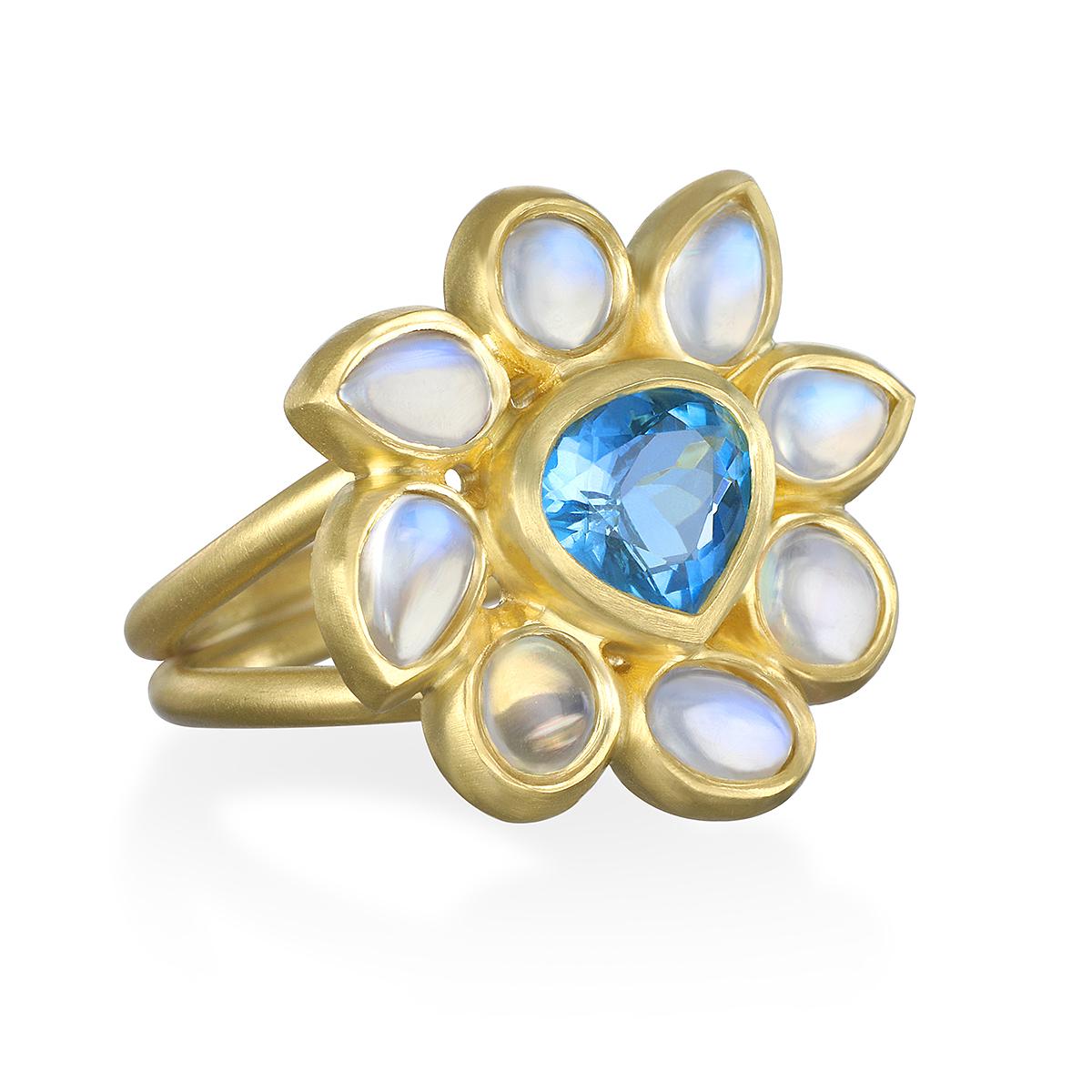 One of a Kind and Unique, Faye Kim's Ceylon Blue Moonstone Daisy Ring features a beautiful deep blue Aquamarine center.  Known for its beautiful adularescence, the blue flash adds to the overall mystique surrounding moonstones and beautifully