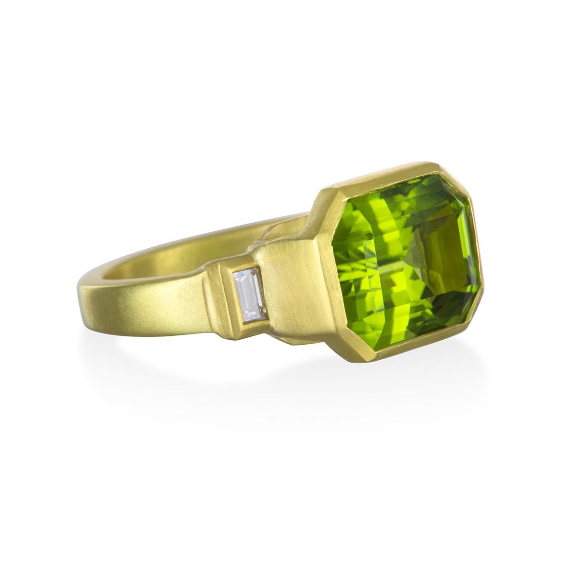 Faye Kim 18k gold modified Emerald-cut Peridot ring with side diamond baguettes.  The main source of Peridot in the ancient world was Topazo Island (now St. John's Island) in the Egyptian Red Sea.  The vivid green color pairs beautifully with the