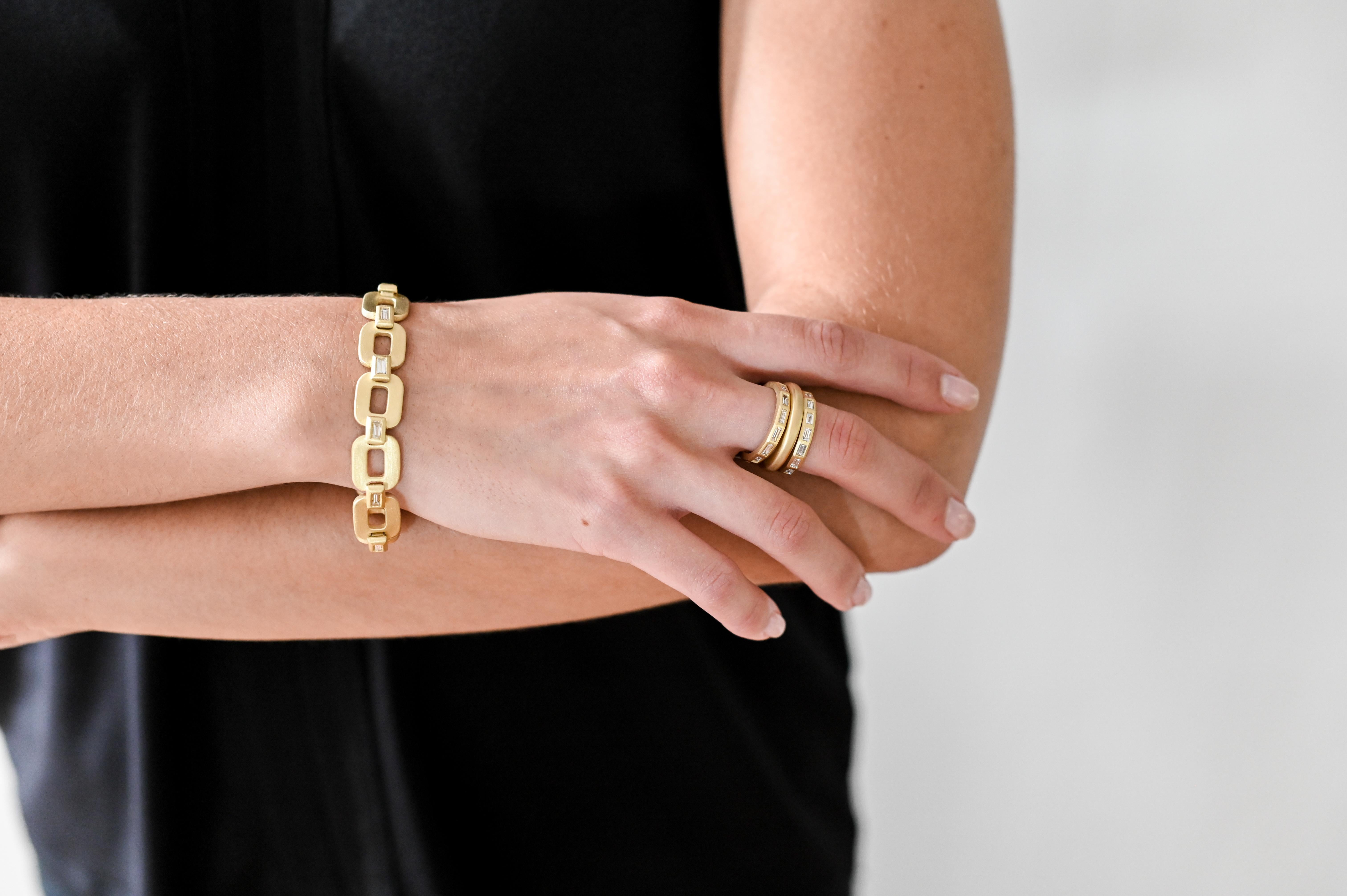 A modern-day classic! Faye Kim's handcrafted 18k gold link bracelet is quite substantial in weight and style. Each cushion-shaped link is polished, matte-finished and expertly linked with a Baguette diamond bezel. The clasp is skillfully crafted