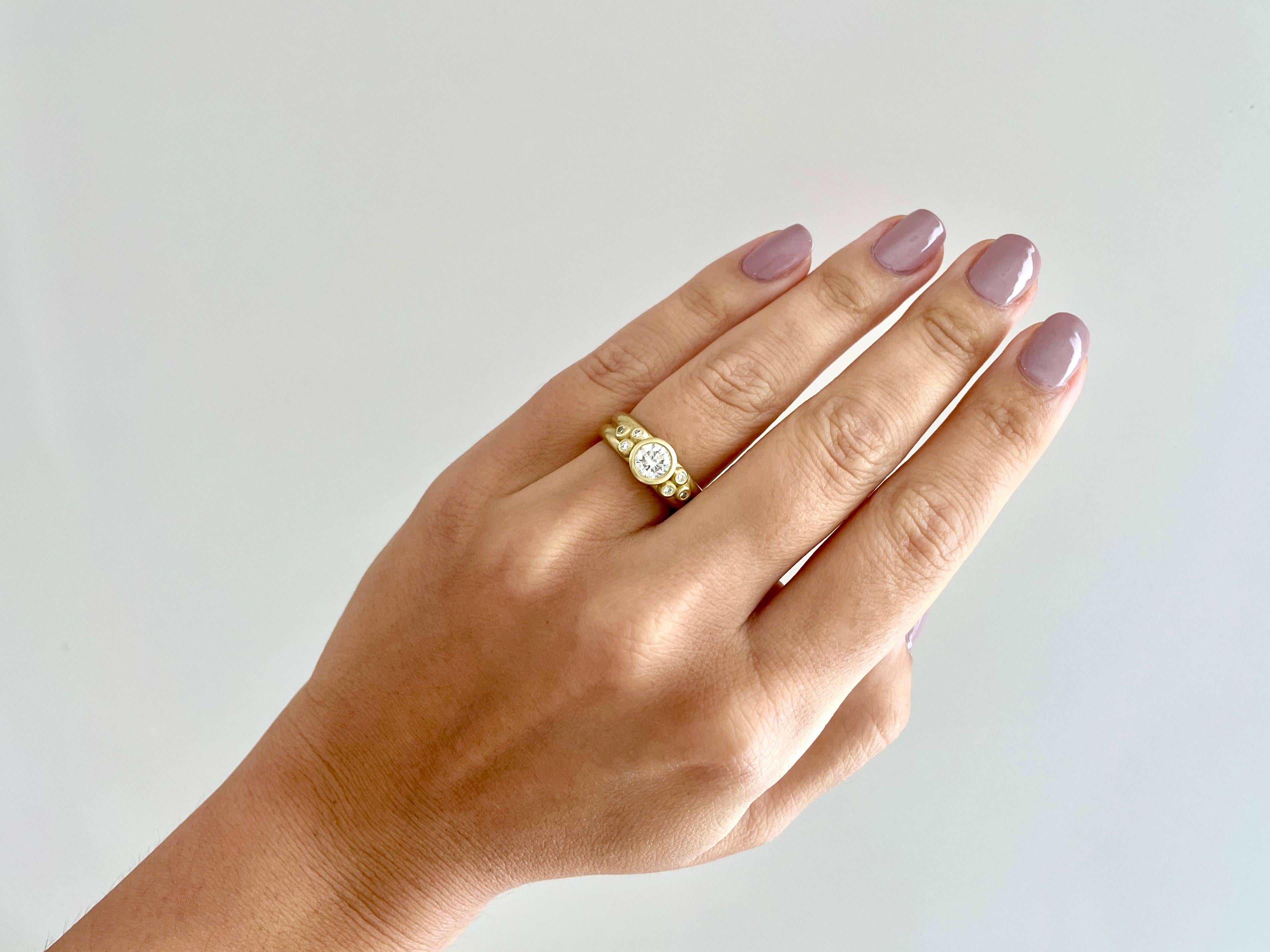 Beautifully handcrafted in Faye Kim's signature 18k Green Gold, a round brilliant cut diamond is bezel set and highlighted further by triple diamond Granulation beads. The double-width shank gives the ring an overall modern vibe that makes it a