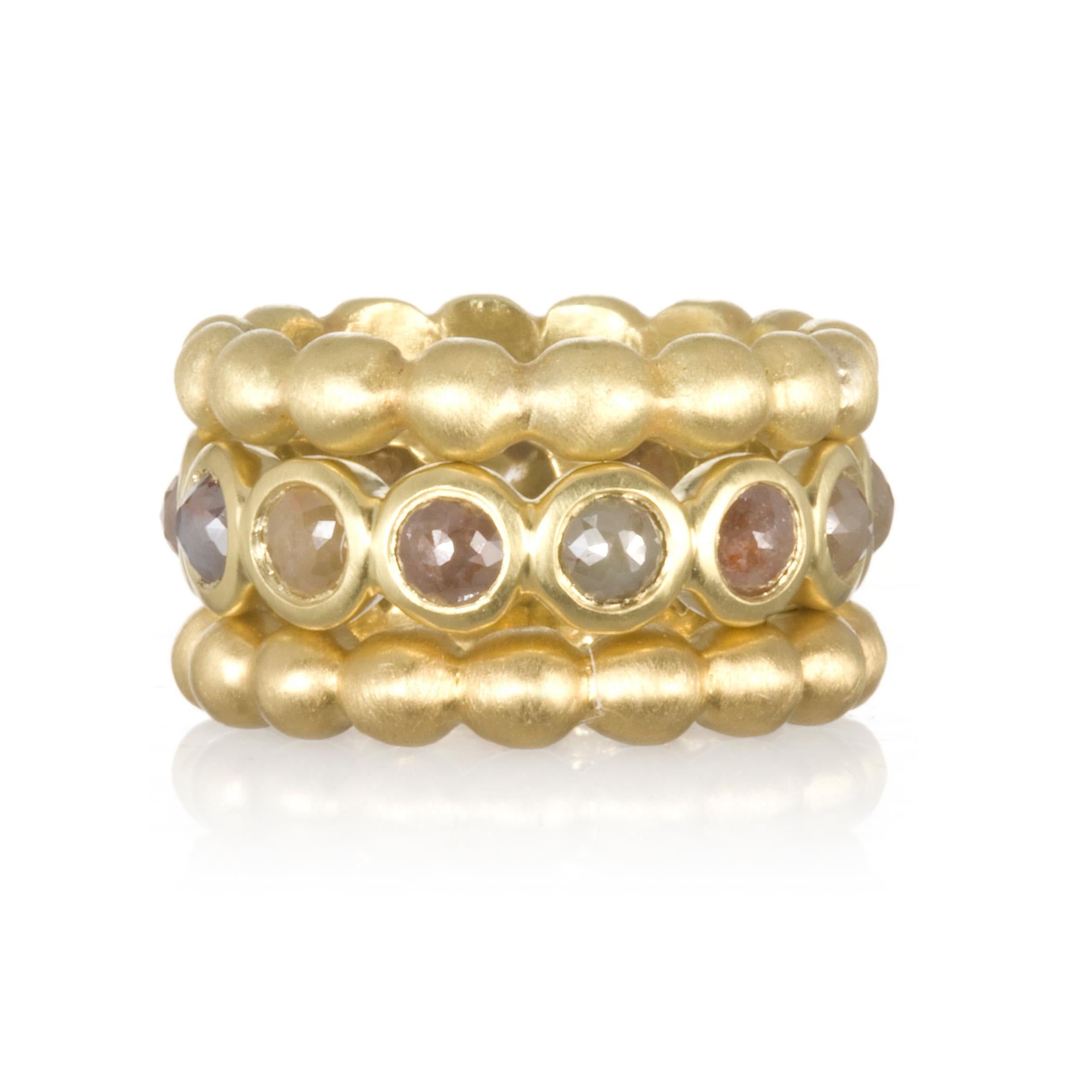 Faye Kim's signature stack band rings in solid 18 karat gold offer style, substance, and comfort. Bright round brilliant cut diamonds add sparkle and interest against the matte-finished rings. Wear them together or mix and match with other bands to