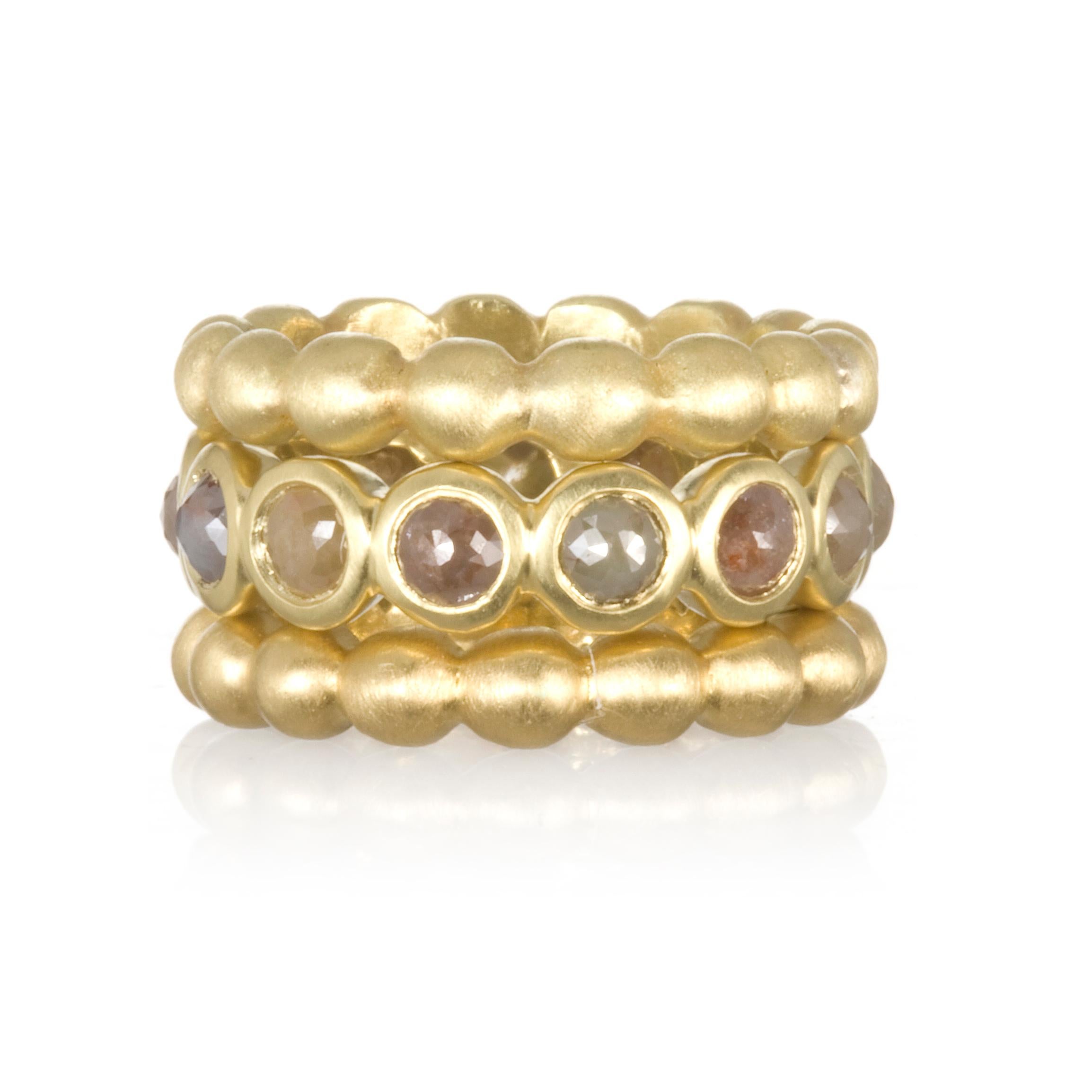 Faye Kim's signature stack band ring in solid 18 karat gold offer style, substance, and comfort. Bright round brilliant cut diamonds add sparkle and interest against the matte-finished rings. Wear them together or mix and match with other bands to