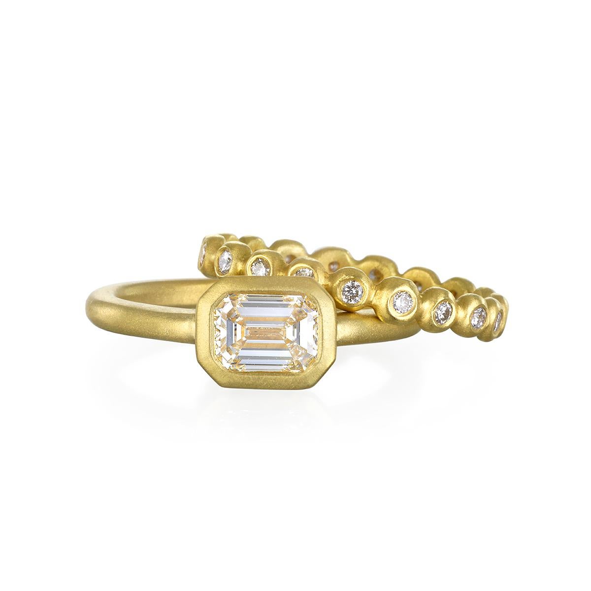 thin gold band with emerald cut diamond