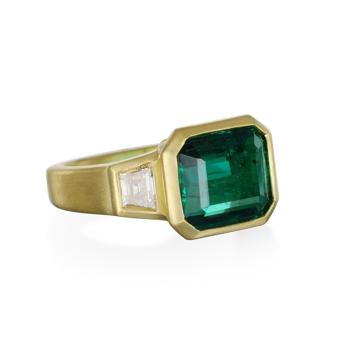 Make a statement with this exquisite 3-stone Brazilian Emerald Ring.  Flanked by trapezoid diamonds in 18k matte gold*, it's perfect as a right-hand statement ring or an engagement ring. 

*In designer Faye Kim's signature 18k green gold, an alloy
