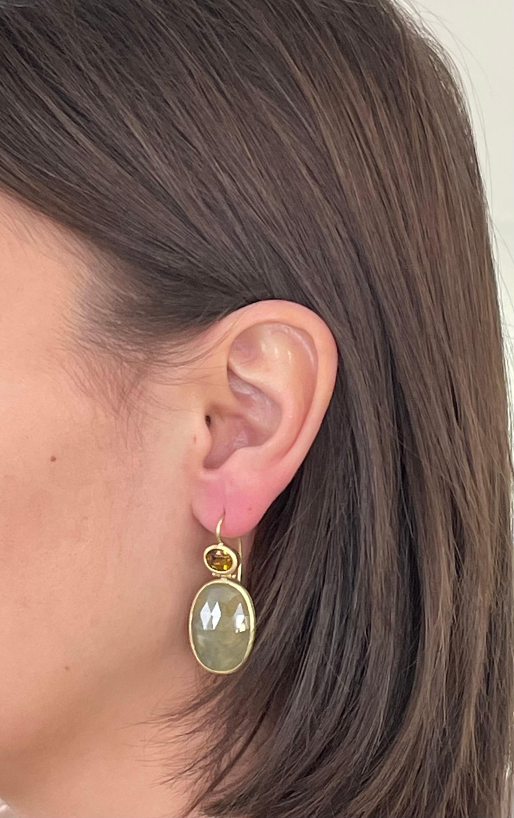 Unique in color and shape, Faye Kim's earrings are handcrafted in 18k gold. Yellow-green sapphire slices are bezel set and paired with oval faceted Mali garnets for a true one of a kind look.
Sapphire - 26.60 Carats
Mali Garnets:  1.52 Carats
Length