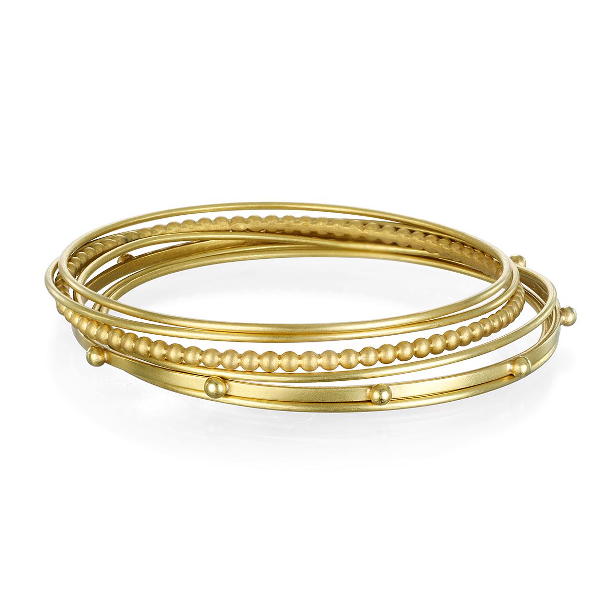 Faye Kim's signature granulation bangle in solid 18k gold* is one of many, designed to wear alone or stack for the ultimate layered look.
Beautifully handcrafted and matte finished. 

*In Faye Kim's signature 18k green gold, an alloy comprising 75%