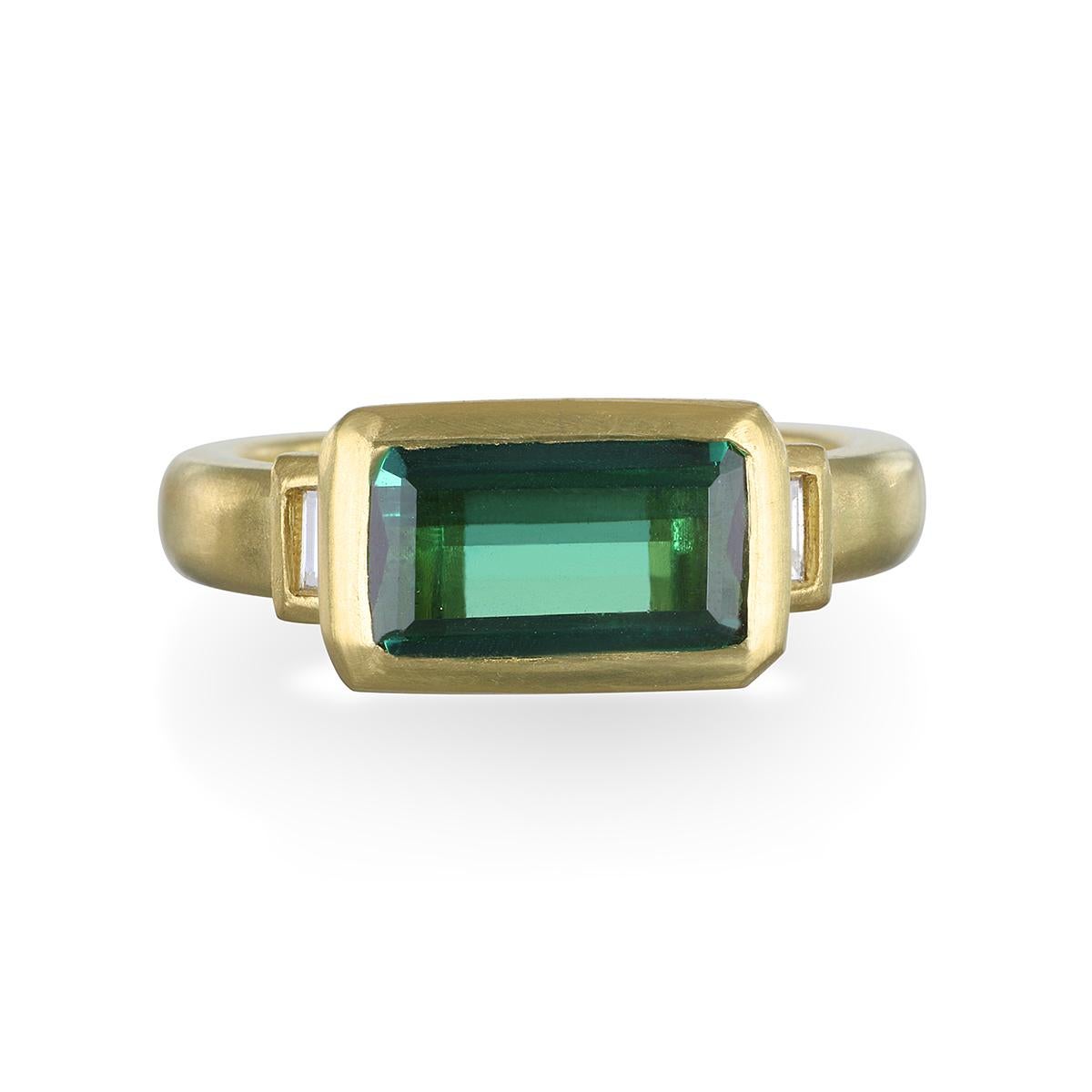 From Faye Kim's newest collection of gemstone rings: 
This vivid green tourmaline is emerald cut and bezel set in 18k gold, complemented with diamond baguettes. The color is bright and even throughout delivering a flawless look!
Size 7
Tourmaline