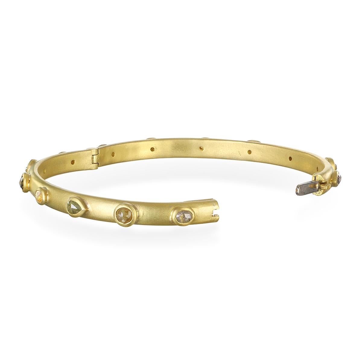 Handcrafted in 18k gold*, Faye Kim’s modern design integrates the natural subtle shades of raw, milky diamonds into a one of a kind hinged bangle bracelet that is both organic and timeless in feel, and which exudes an understated elegance. Can be