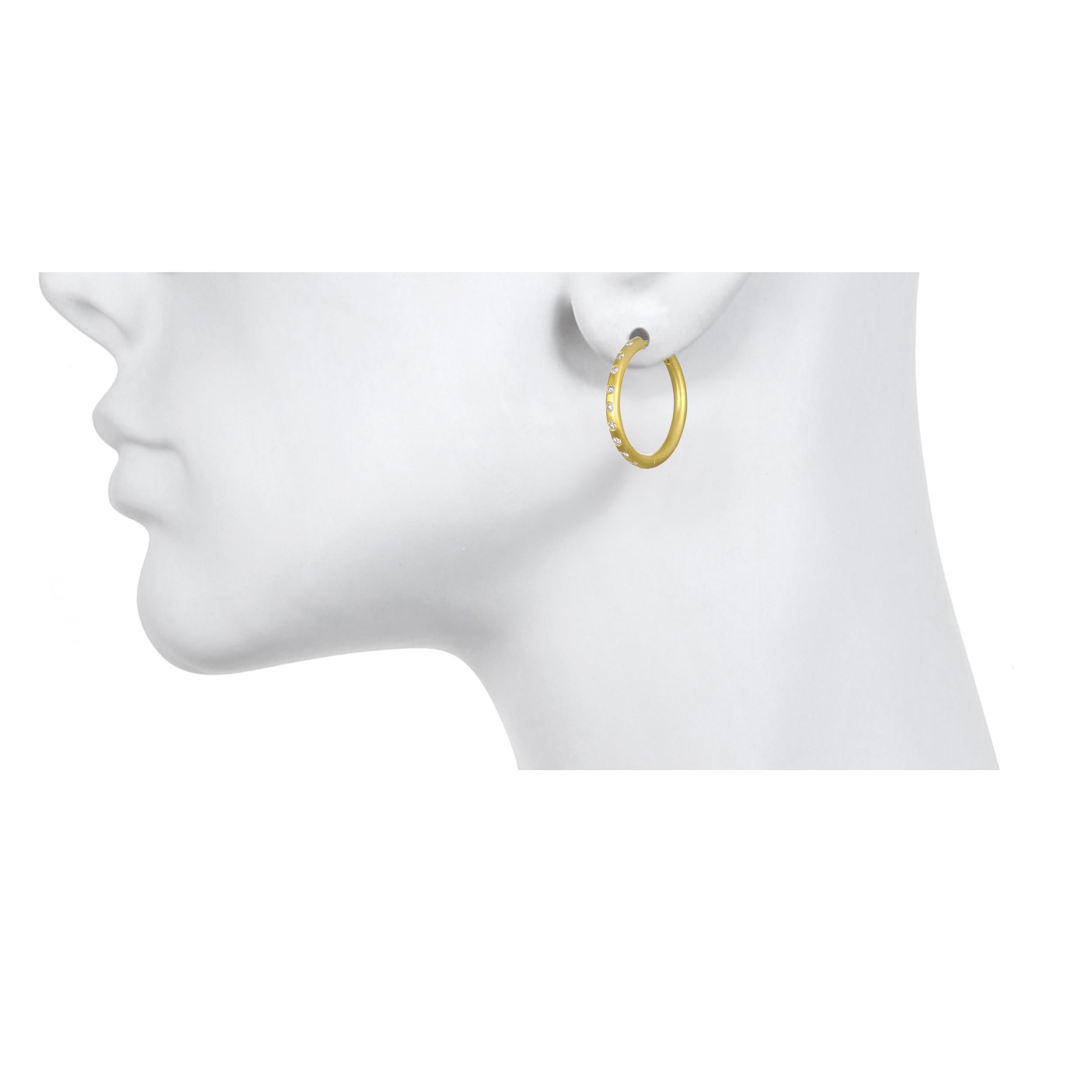 Handcrafted in 18K Green Gold, Faye Kim’s modern hoop design conveys understated elegance and a truly stylish, everyday look! Hoops are solid with a hinged mechanism. Complete with burnished diamonds for extra sparkle!

Diamonds = .38 carats twt,