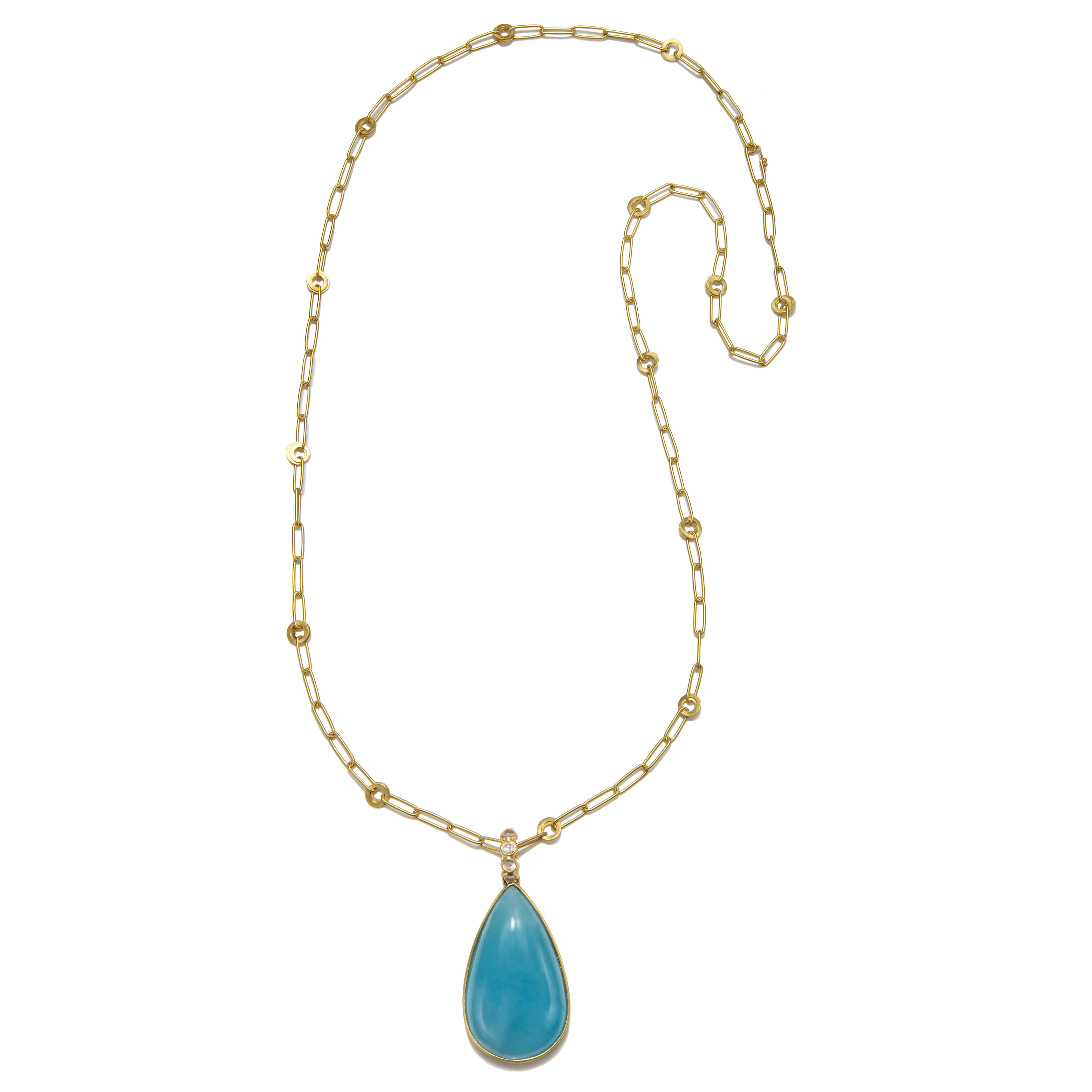 One of a kind, pear-shaped milky Aquamarine set in 18k gold. Finely crafted, the bail features moonstone cabochons to accentuate and highlight the beauty of the milky aquamarine cabochon. Slight natural inclusions.

Aquamarine = 108 carats
Pendant