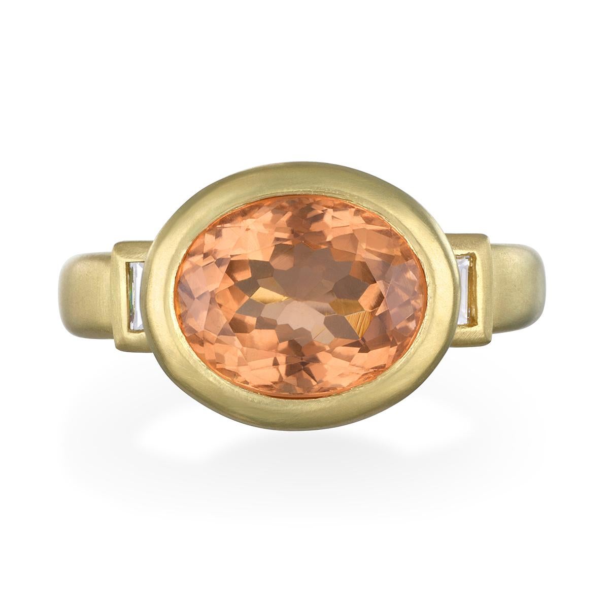 An updated version of the classic three-stone ring. Beautifully handcrafted in 18k gold, a fancy colored 