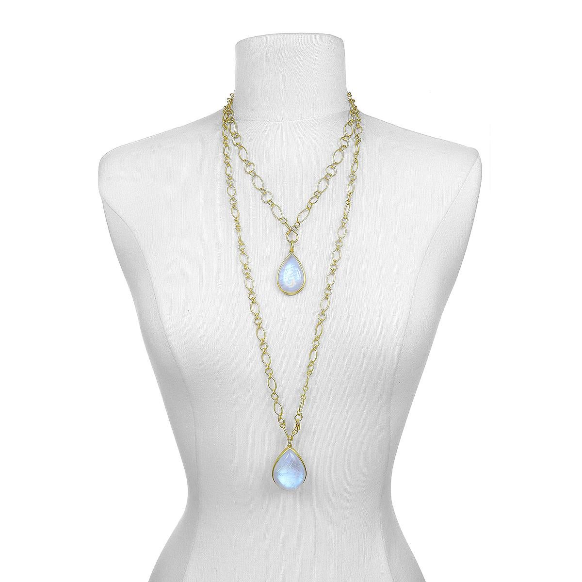 This beautiful Moonstone Bezel Pendant is full of light and reflects beautiful translucent blue hues. The elegant pear shape, polish, and matte gold enhances the moonstones striking rainbow effect. Handcrafted in 18k gold with a classic jump ring