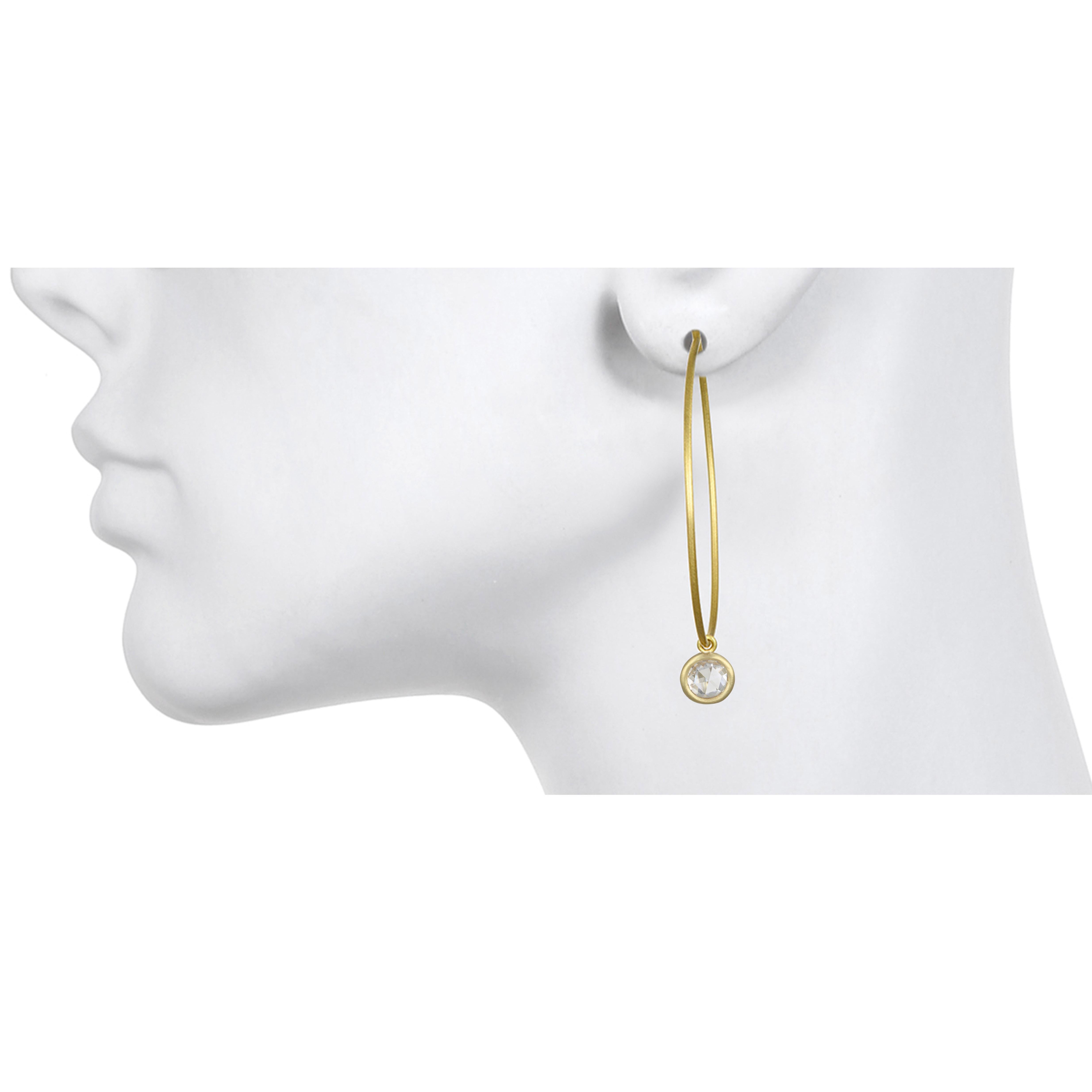 Faye Kim's 18k Green* Gold classic and timeless thin wire hoops are accented with White Sapphire drops. Faceted like diamonds, white sapphires add a bit of sparkle for day or evening. Drops are detachable so hoops can be worn alone. 
Hoops: 1.75