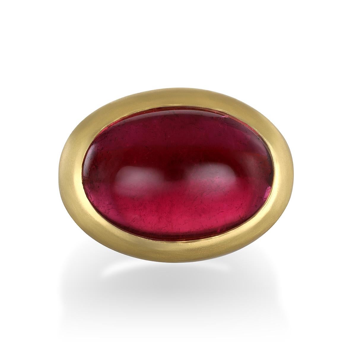 Faye Kim's 22 Karat Gold Pink Tourmaline Hinged Cabochon Ring, with its oversize stone and intriguing berry hue, is beautifully bezel set and matte finished. The ring can be worn for any occasion and is and is certain to be a conversation
