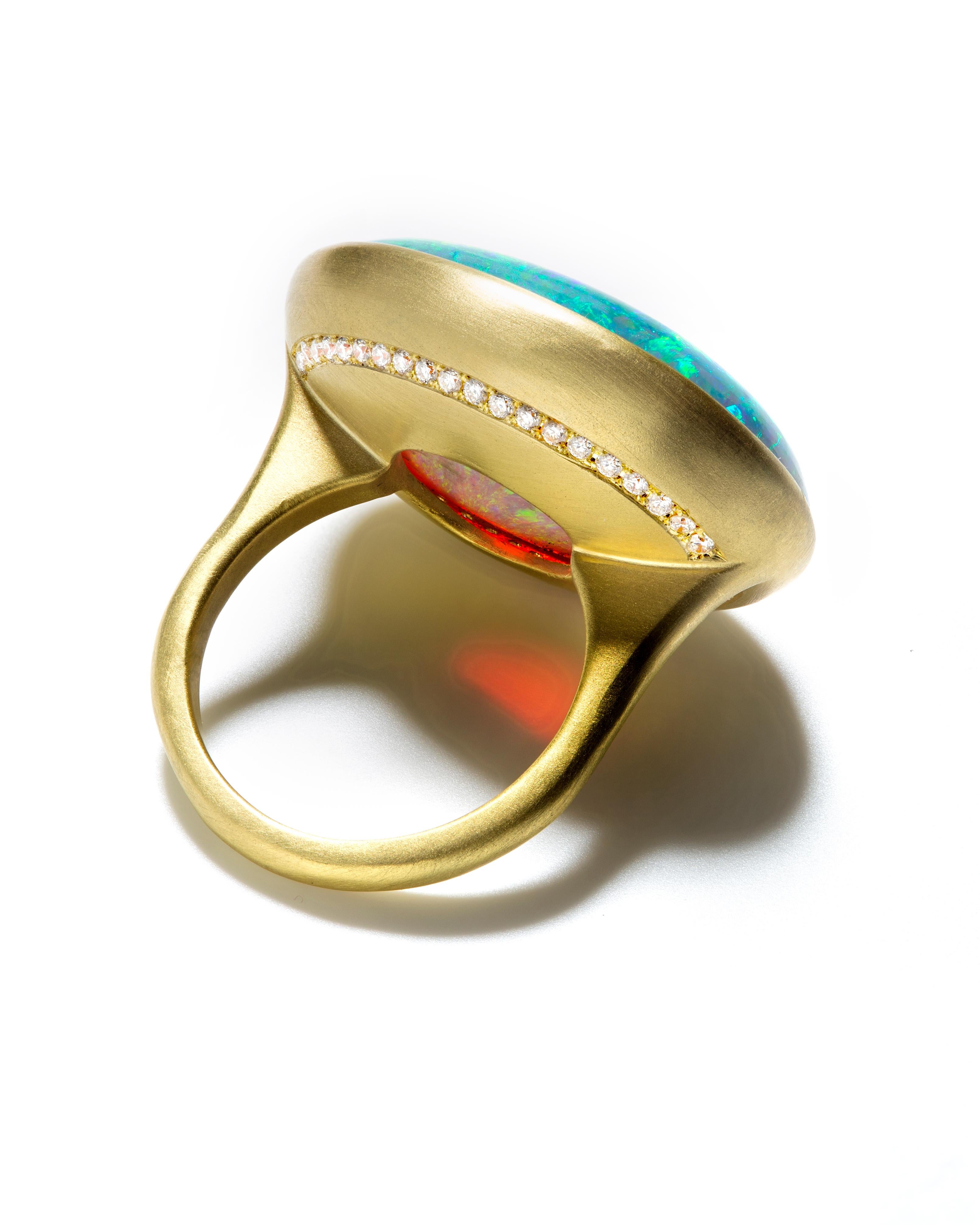 Stunning Australian Crystal Opal in 18k green gold setting.
Mined in the Corcoran Field Lightning Ridge in Southern Australia, this opal's striking color palette sets it apart from other gemstones. Handcrafted in 18k gold and accented with a