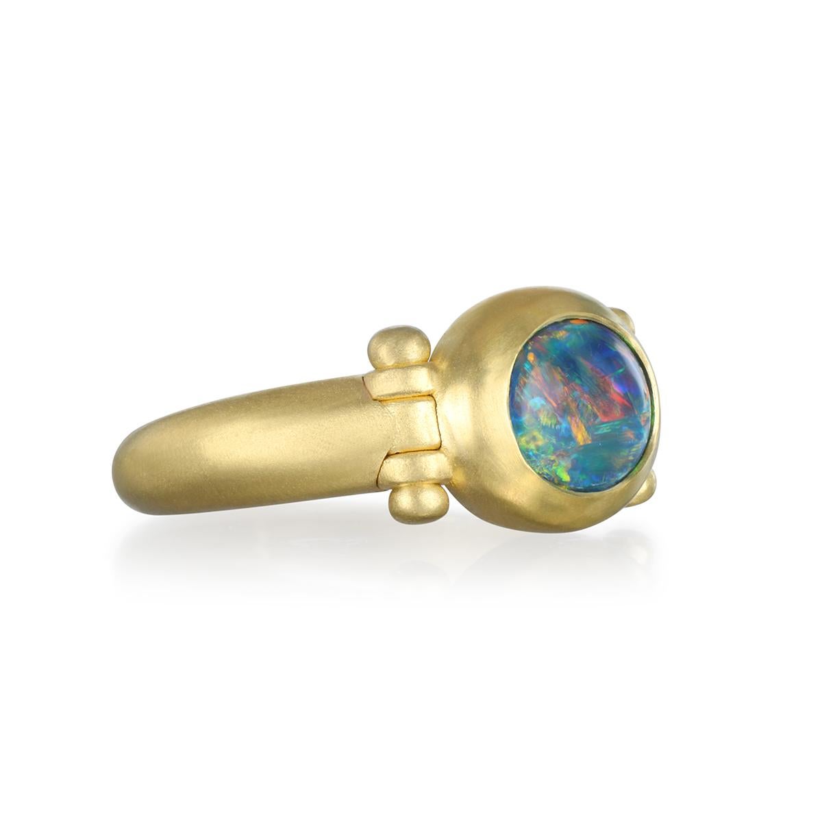 A captivating blend of artistry and modern refinement, Faye Kim's 18 Karat Gold Black Opal Hinge Ring showcases a richly colored black opal set in warm 18 karat gold. The stone’s mesmerizing play of color is emphasized by Faye Kim’s signature matte