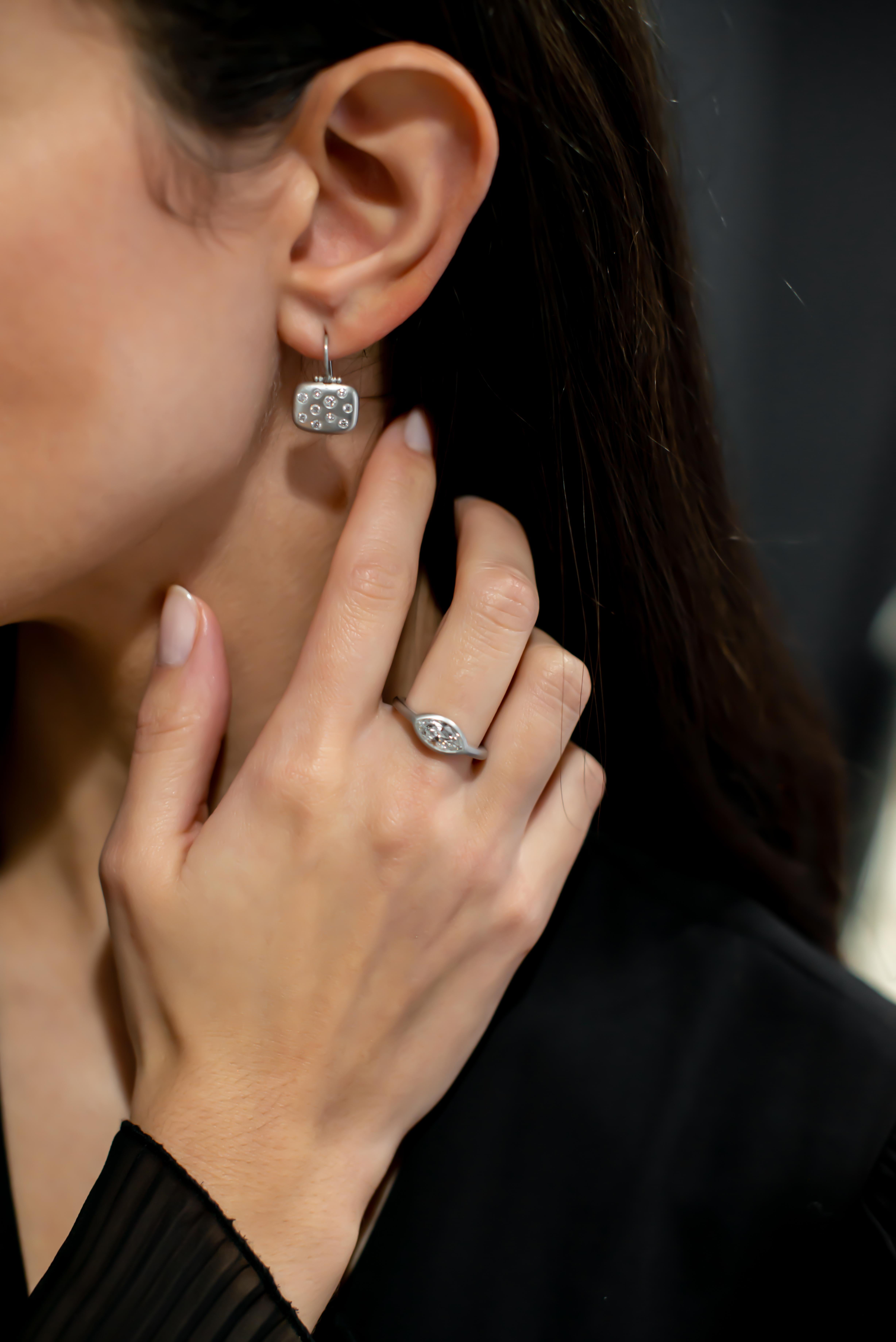 Los emblemáticos pendientes de platino mate de Faye Kim están acabados con alambres de bisagra.  Los diamantes bruñidos resaltan sobre el acabado en platino mate para un aspecto moderno y fresco.  Su diseño limpio y elegante no pasará desapercibido.