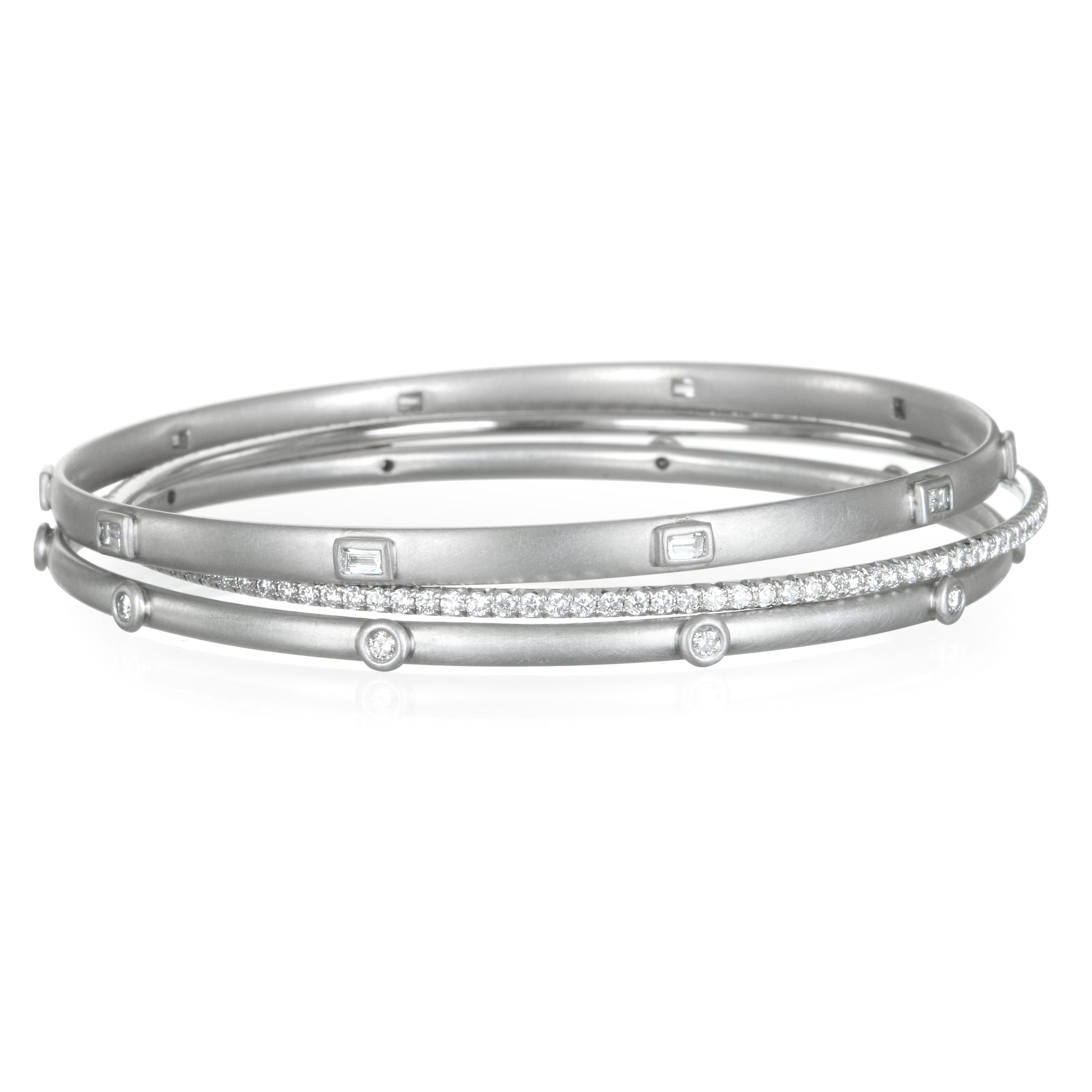 Faye Kim's handcrafted diamond baguette bangle in platinum is modern-casual with a sophisticated flair. The matte finish contrasts beautifully with the sparkle of diamonds. 
Perfect on its own or stack with other bangles for your own unique