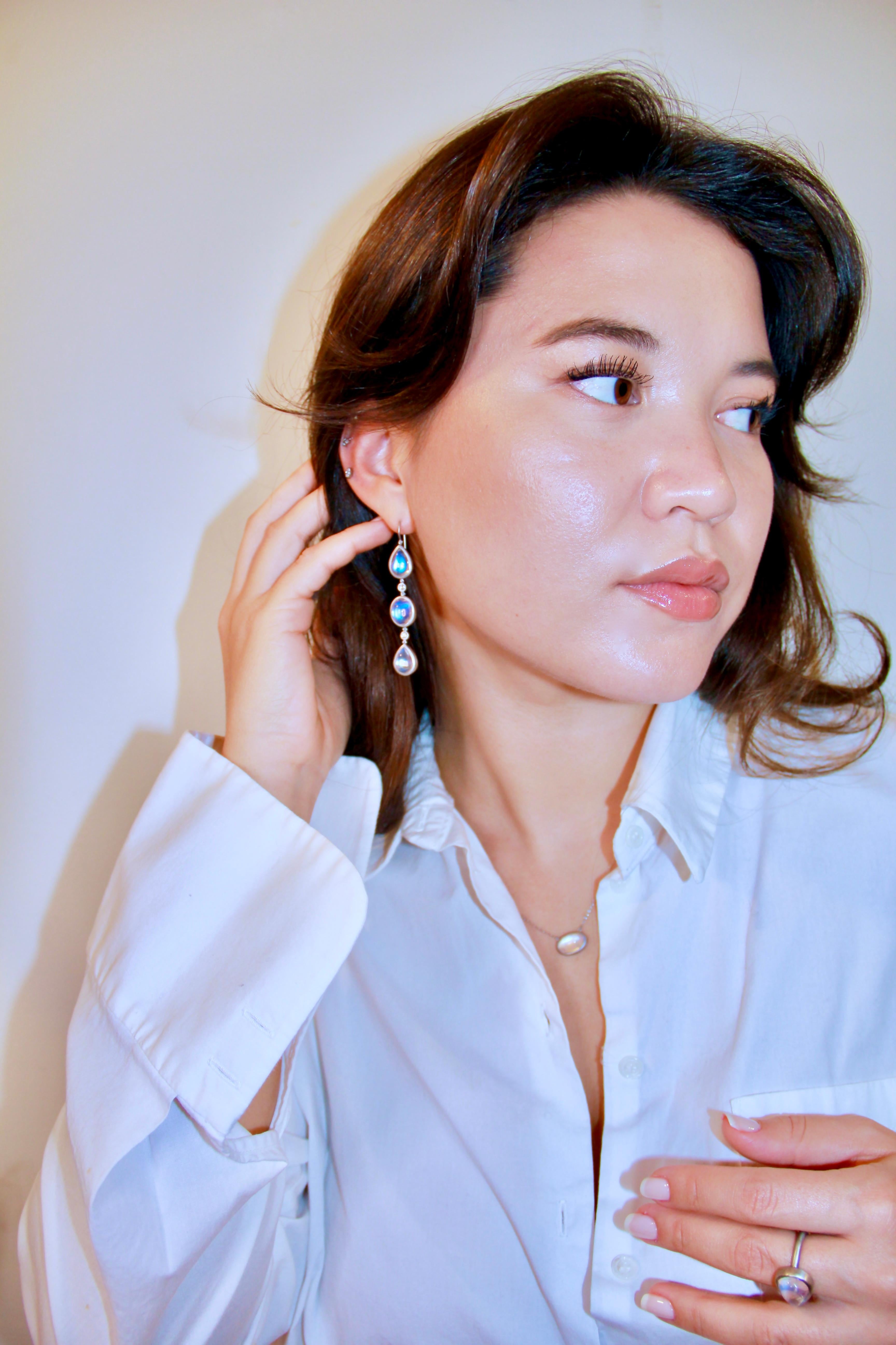 Faye Kim's Platinum Diamond Ceylon Moonstone Line Earrings are beautifully crafted and showcase spectacular oval and pear-shape moonstones separated by sparkling round white diamonds. Perfect for every occasion!

Moonstones 24.54 tcw
Diamonds .28