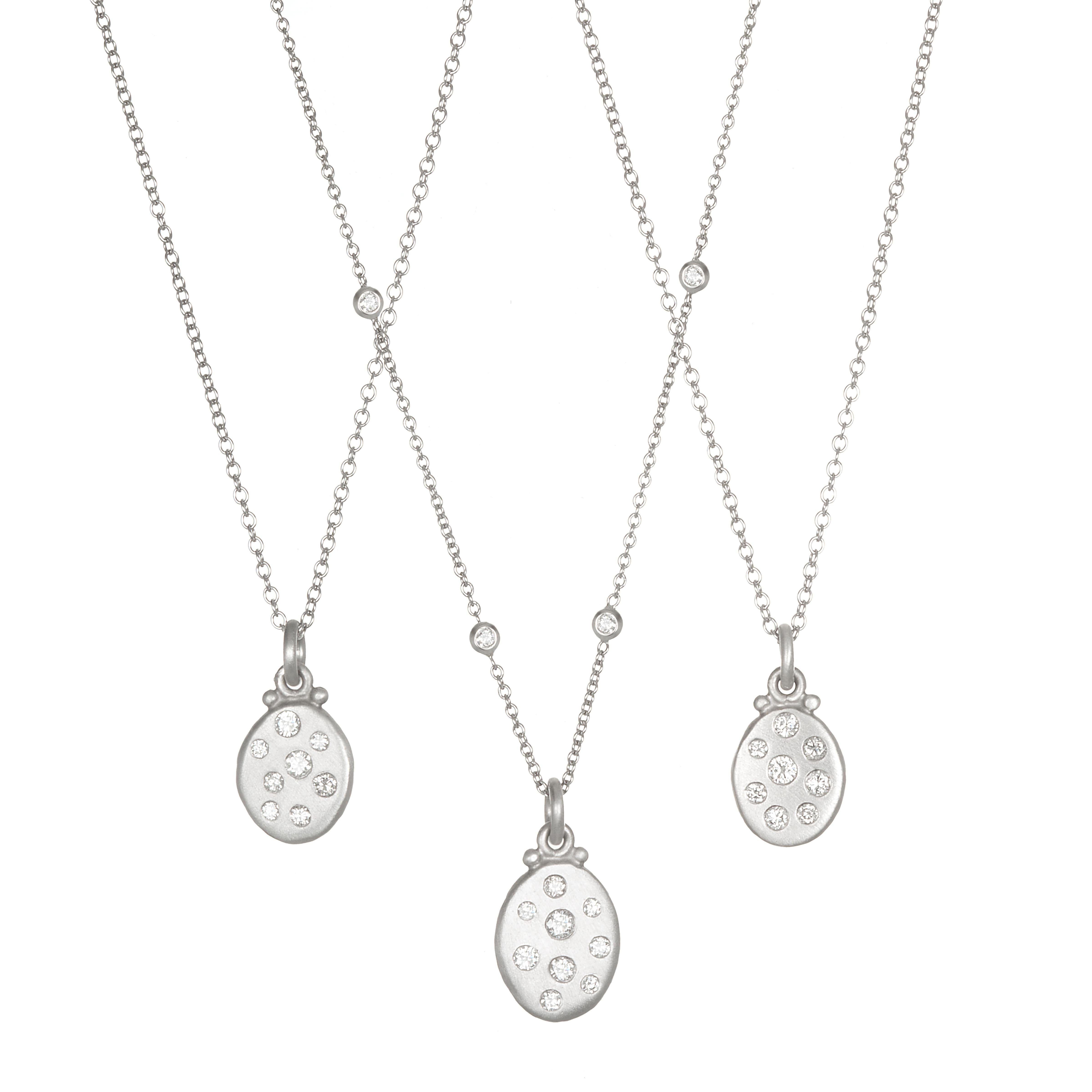 Versatile and easy to wear, the mini version of Faye's popular diamond Dog Tag pendants are perfect for everyday wear. The pendant is matte-finished in Platinum and hangs on a diamond station necklace for added sparkle. Whether worn alone or