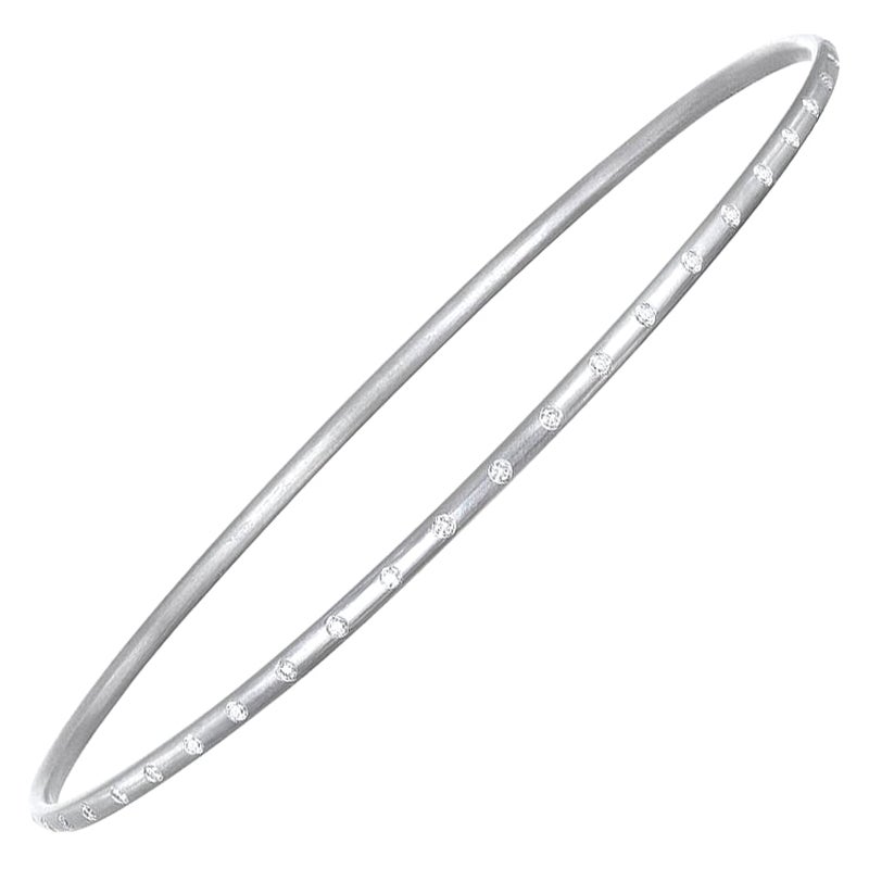 Handcrafted in platinum with delicate diamond detail, this diamond burnished bangle is beautifully sleek. Wear alone or complete the look with a variety of shapes and textures. Each bangle sold individually.

50 Diamonds = .51 cts twt
Inner diameter