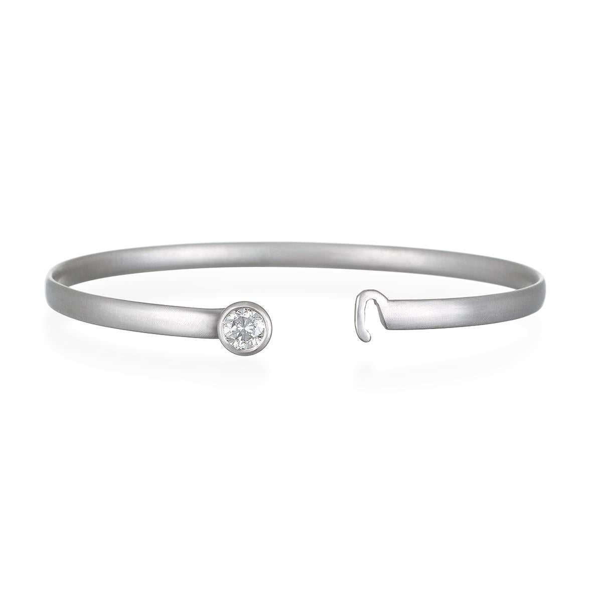 Faye Kim has set this round brilliant cut solitaire diamond into a classic platinum button bangle bracelet, perfect for wearing alone or stacking with other bangles. Ideal for any occasion, from work to wedding.

G Color, VS Clarity .71