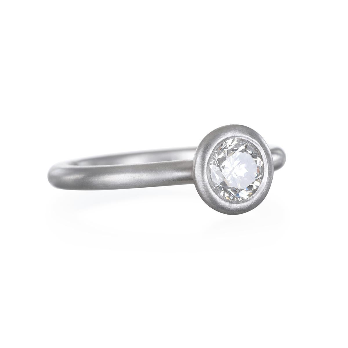 This timeless yet contemporary platinum diamond engagement ring. Bezel set with an open gallery for an airy feel, with a matte finish.
Can be stacked, mixed and matched to create your own style. 

Size 6.75  Ring can be sized.
Diamond: Round