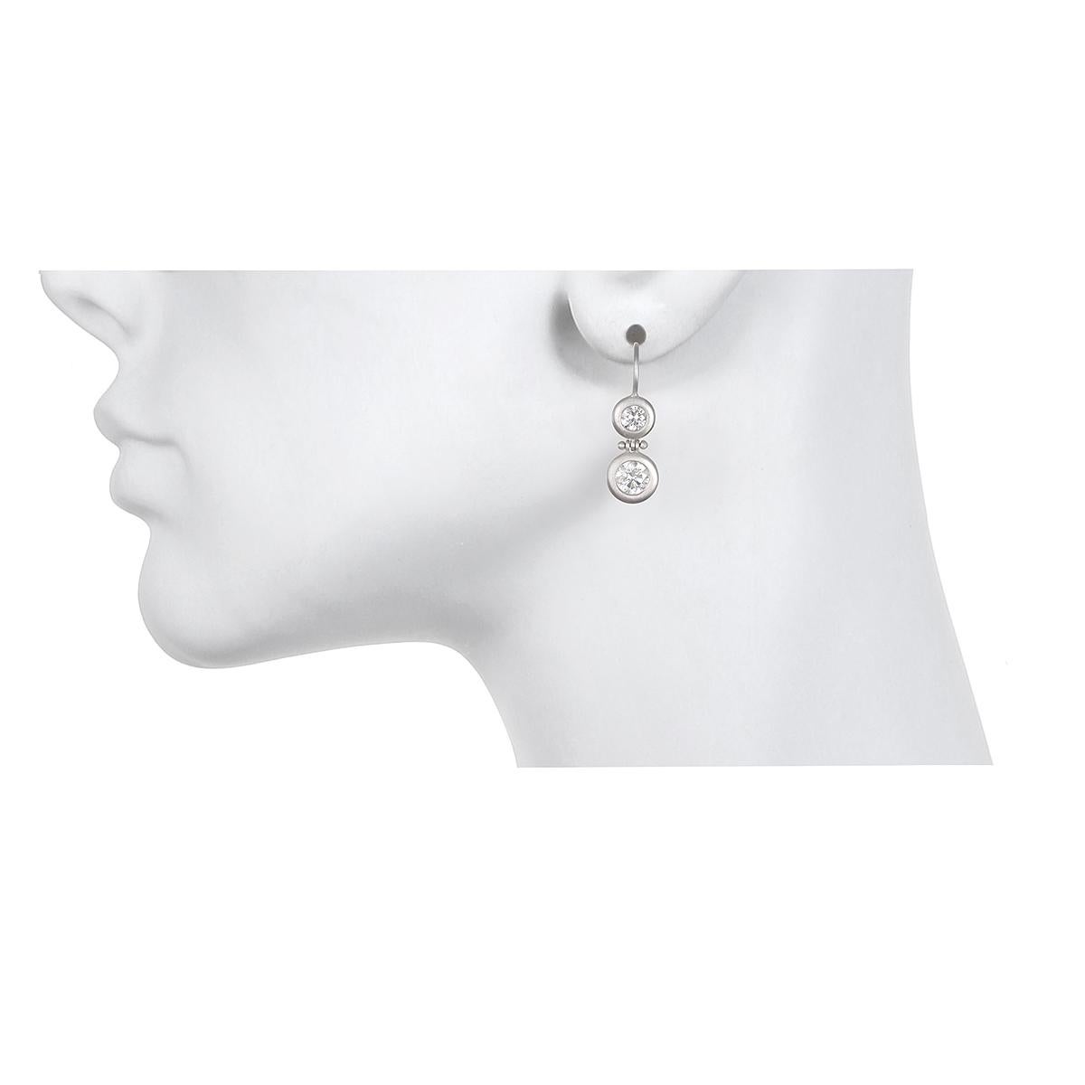 Effortlessly transition from simple and chic for every day to special occasion evening wear. 

Handcrafted in Platinum and matte finished, these double round brilliant cut diamonds are paired together for a classic yet modern look. The hinged ear