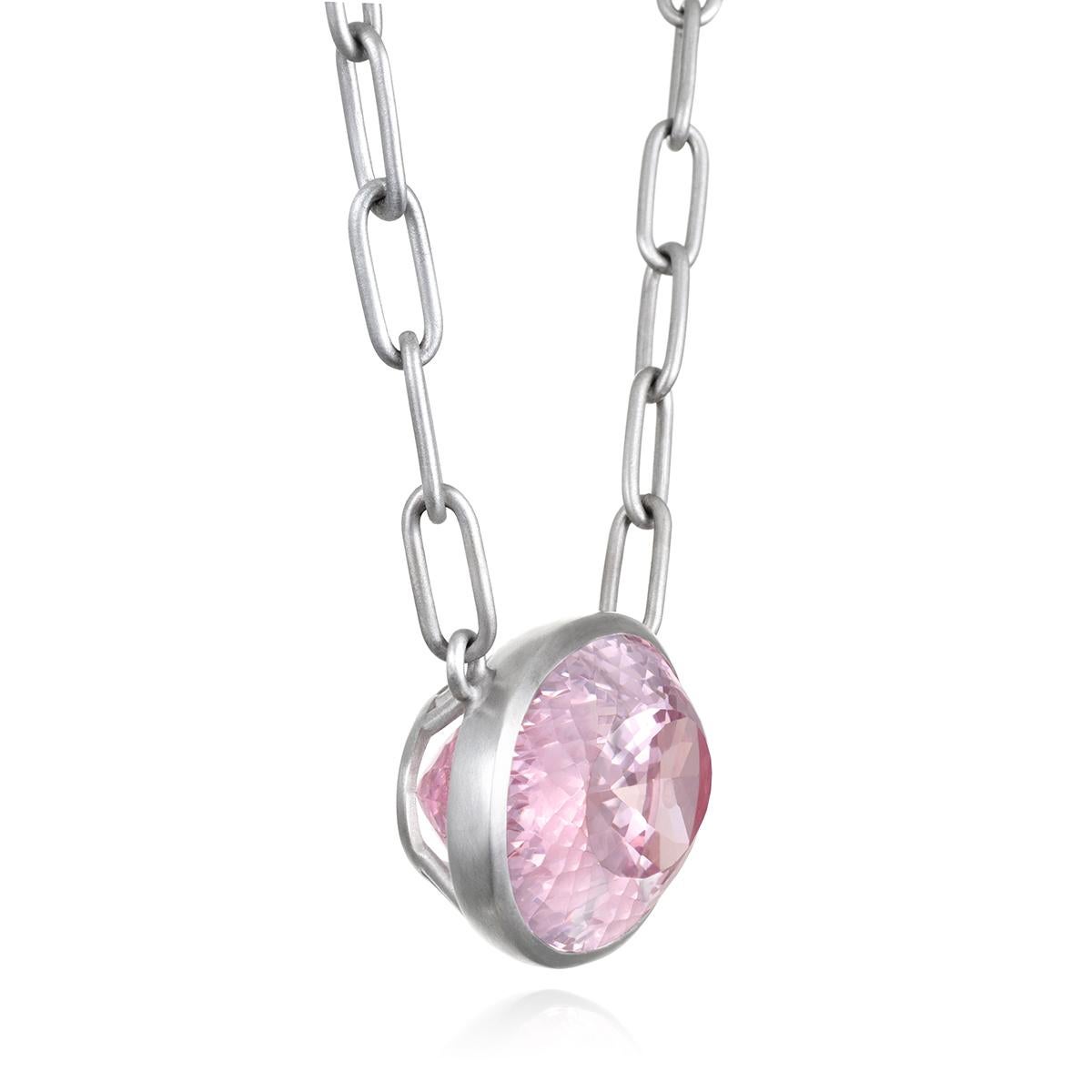 Faye Kim's one-of-a-kind Platinum Faceted Oval Kunzite Paperclip Chain Necklace, with its soft lilac-pink color, faceted finish, and open bezel, is striking in appearance. 

Complemented by Faye Kim's signature matte finished platinum paperclip