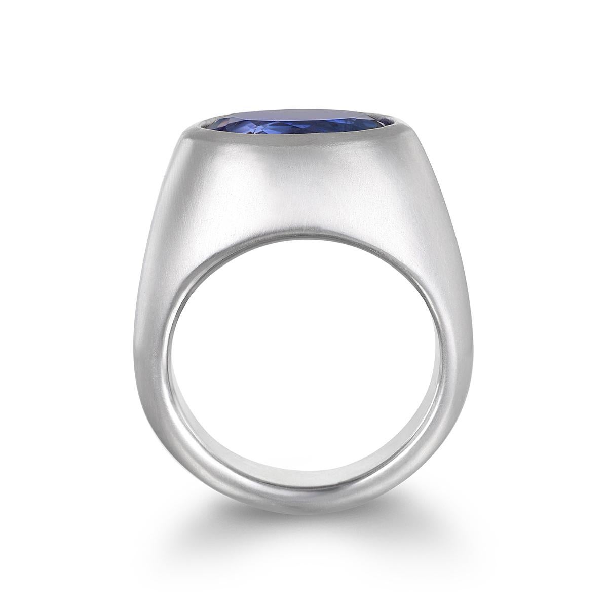 Faye Kim's Platinum Faceted Oval Tanzanite Dome Ring, with its clean, understated design and smooth, polished matte finish, showcases a stunning Tanzanite stone. The ring's slightly chunky and effortlessly chic style enables it to be incorporated