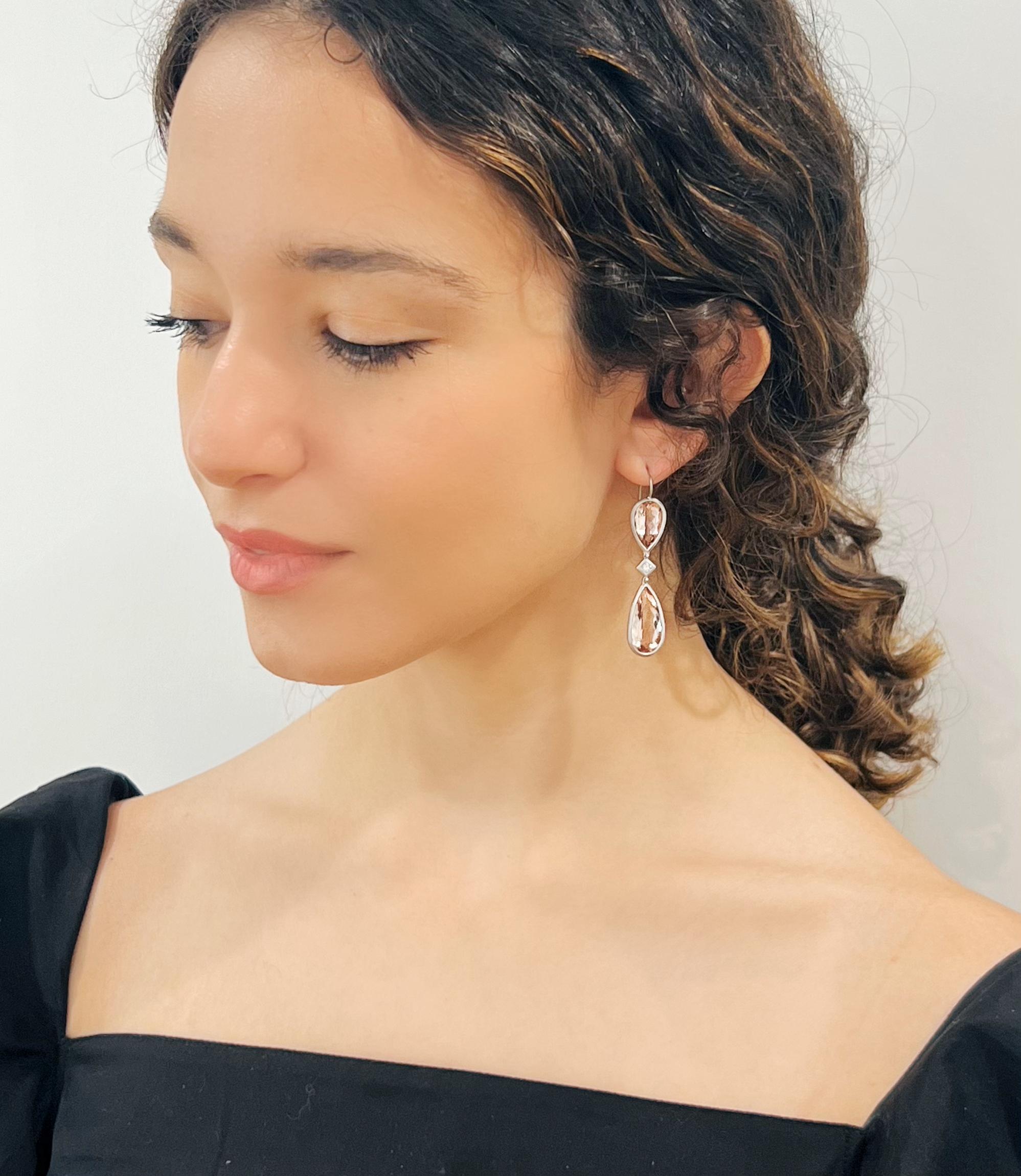 One of a kind!
Beautifully matched in color and shape, these faceted Morganite pear-shaped drops are joined by princess cut diamond accents. The contemporary matte platinum finish highlights their perfectly sophisticated shade of pink. Morganite is