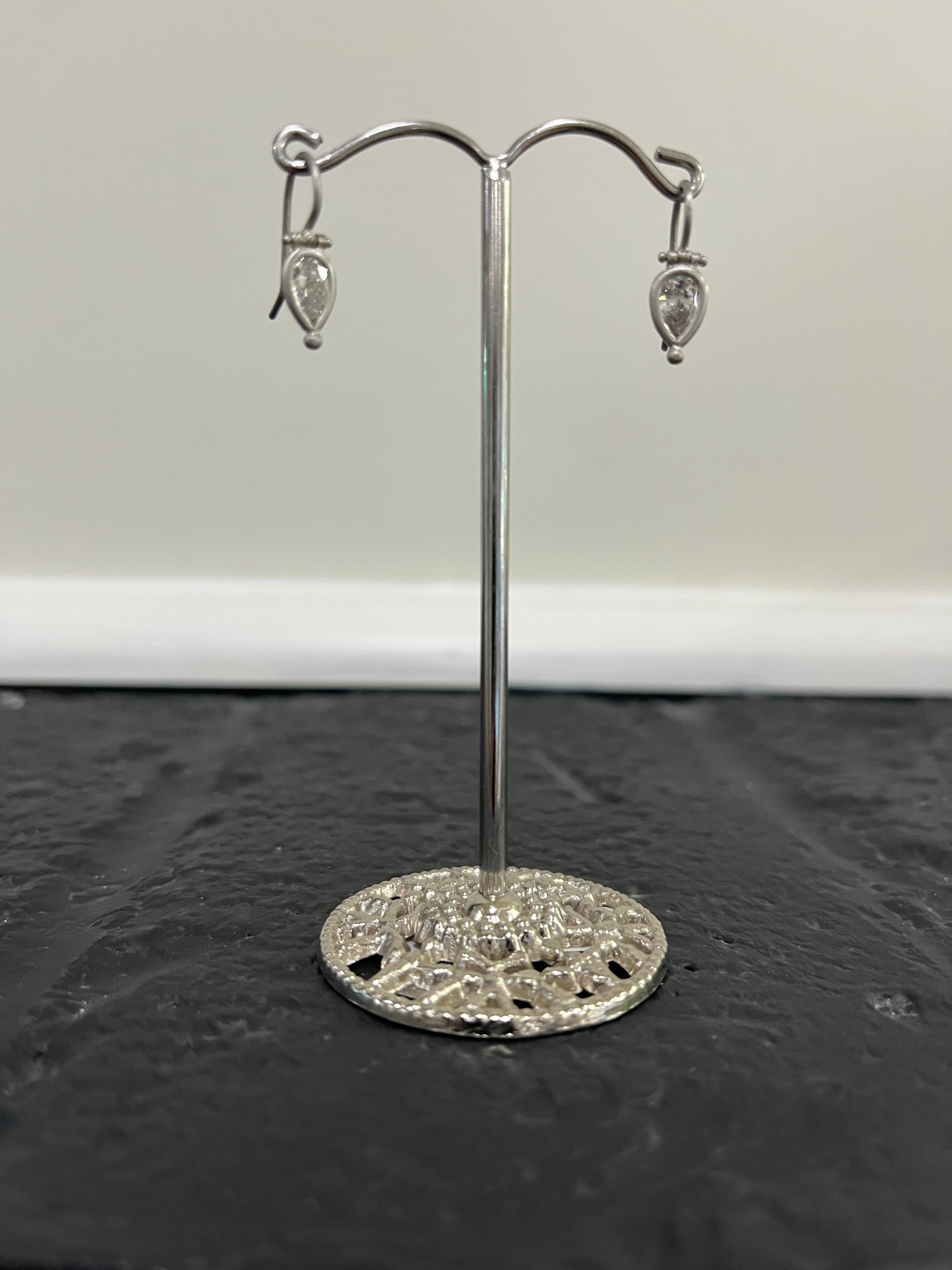 Faye Kim Platinum Pear Shape Diamond Hinge Earrings - the quintessential perfect pair of diamond earrings. Just enough sparkle to get noticed but with understated elegance. The hinge detail provides movement and the bezel setting makes the diamonds