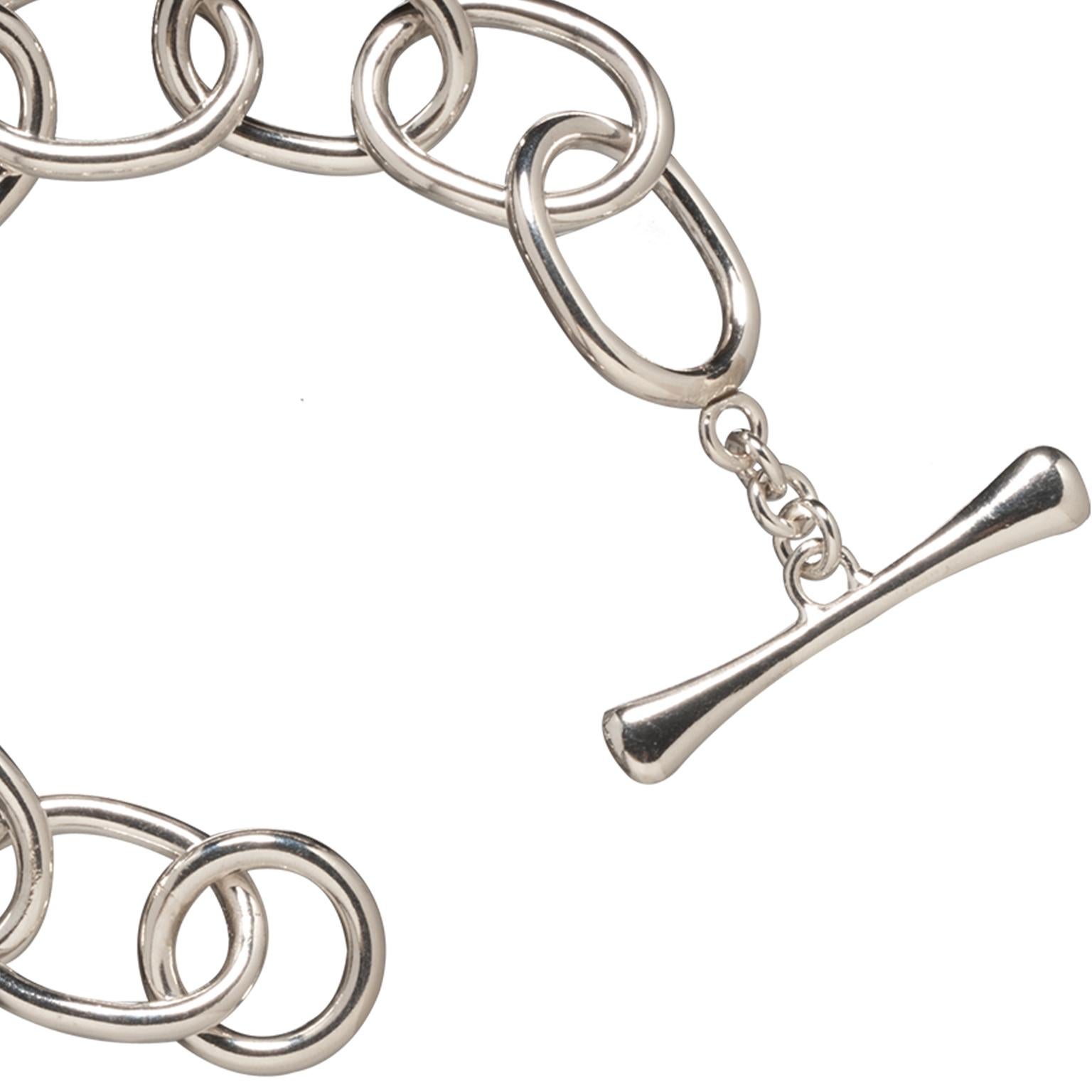 A twist on the classic chain link bracelet, Faye Kim's oval link bracelet is a statement piece with impact!  Extra large oval links are handmade with thick sterling silver wire to give the bracelet substance.  The over-sized toggle is the perfect
