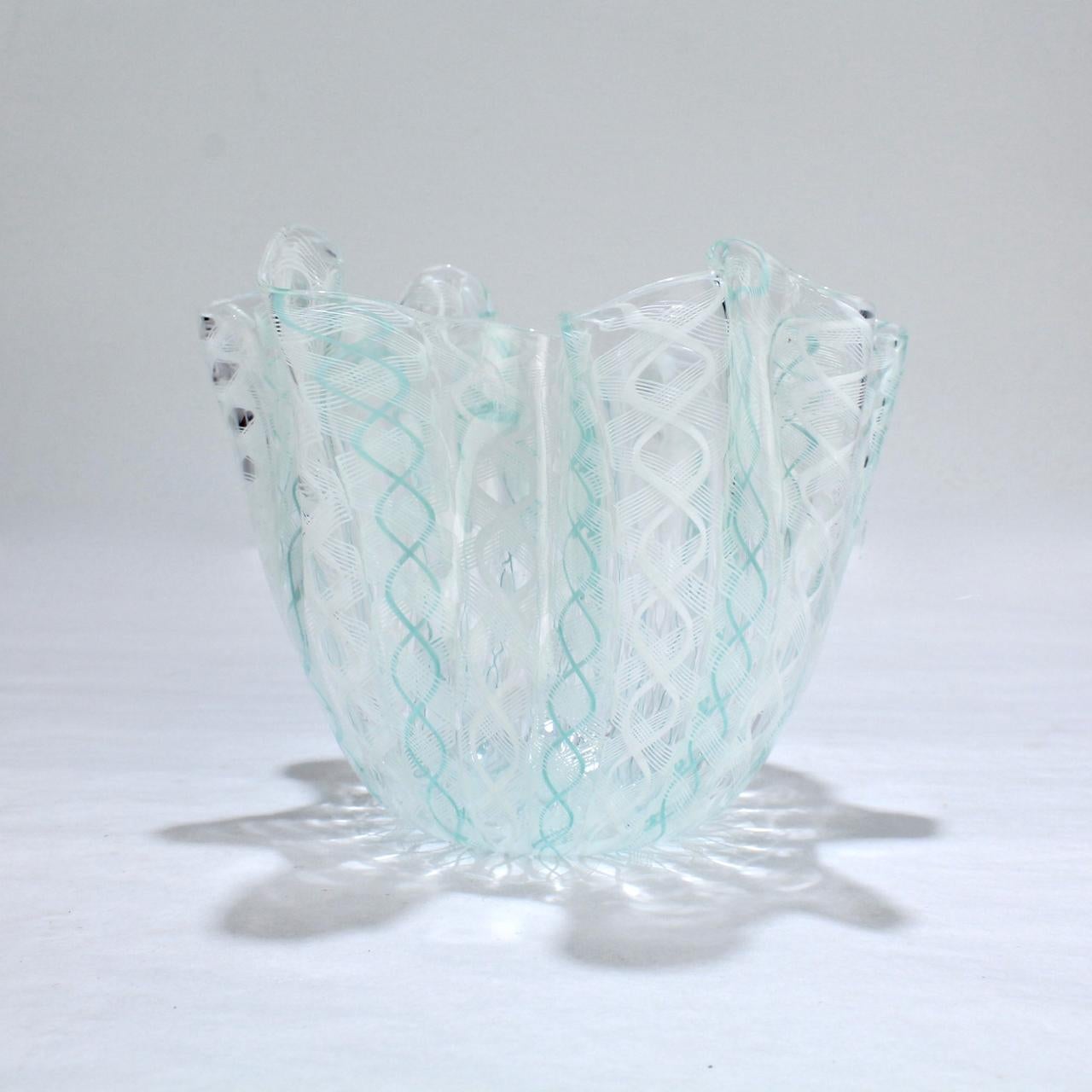 A fazzoletto or 'handkerchief' glass vase in teal green and white.

Designed by Fulvio Bianconi and Paolo Venini for Venini glass.

An iconic Mid-Century Modern form and an essential piece of Italian glass.

The base bears a 3 line acid-etched
