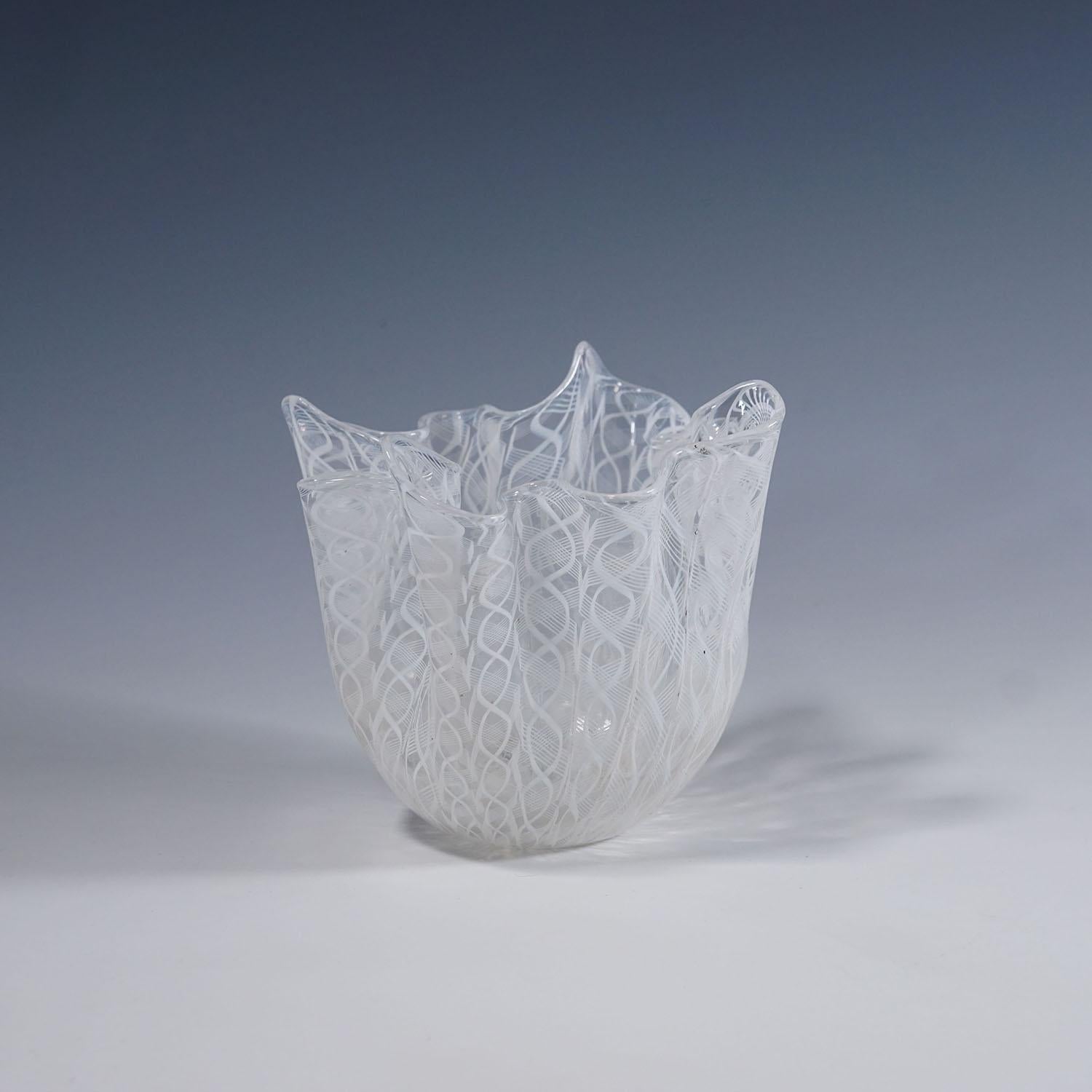 Fazzoletto Zanfirico Vase by Fulvio Bianconi for Venini, Venice Murano 1950s

A rare Fazzoletto (handkerchief) vase in transparent glass with turned white rod decorations called 'Lattimo Zanfirico'. Manufactured ca. 1950s by Venini, Venice after a