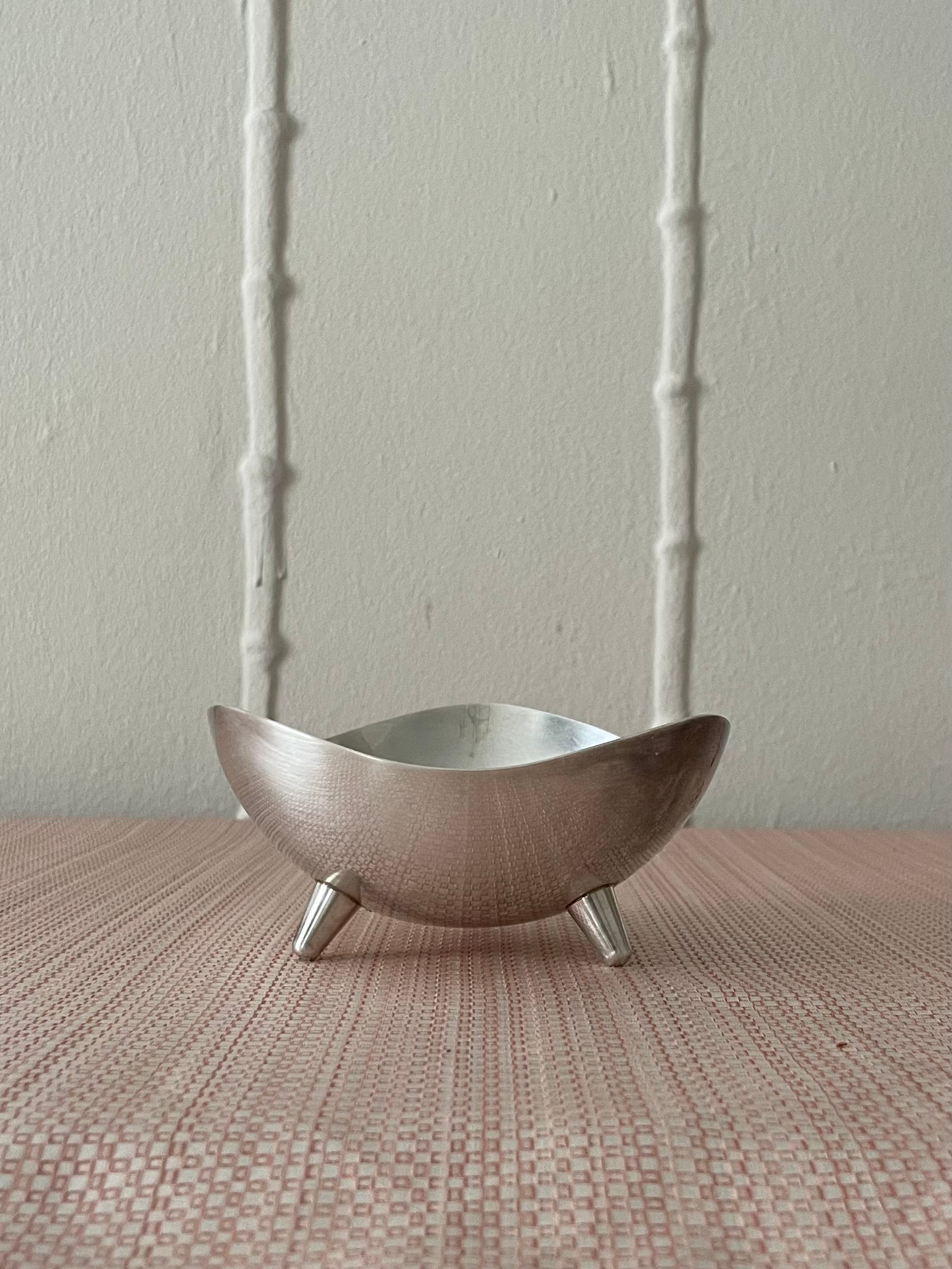 Silver plate bowl made by F.B. Rogers Silver Co. Lifted by a set of cute module feet, iconic midcentury modern. This bowl is ready to hold coins, keys to the guest house, matches, 420, business cards or whatever else you have laying around.