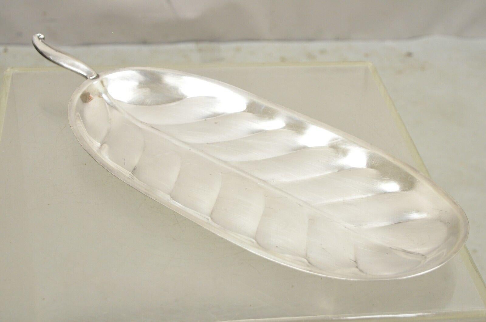 F.B. Rogers Silver Plate Oval Banana Leaf Form Serving Tray Platter with Handle. Item features the original label, clean modernist lines, great style and form. Circa Mid 20th Century. Measurements: 1.5
