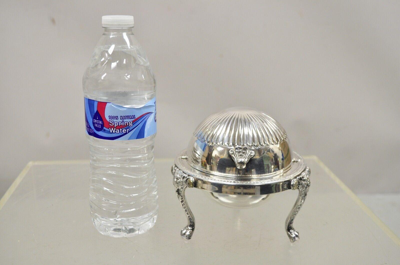 F.B. Rogers Victorian silver plate round roll top butter dish with liner. Item features a glass liner, roll top, lions head and paw feet. 
circa Early 1900s. Measurements: 4.5