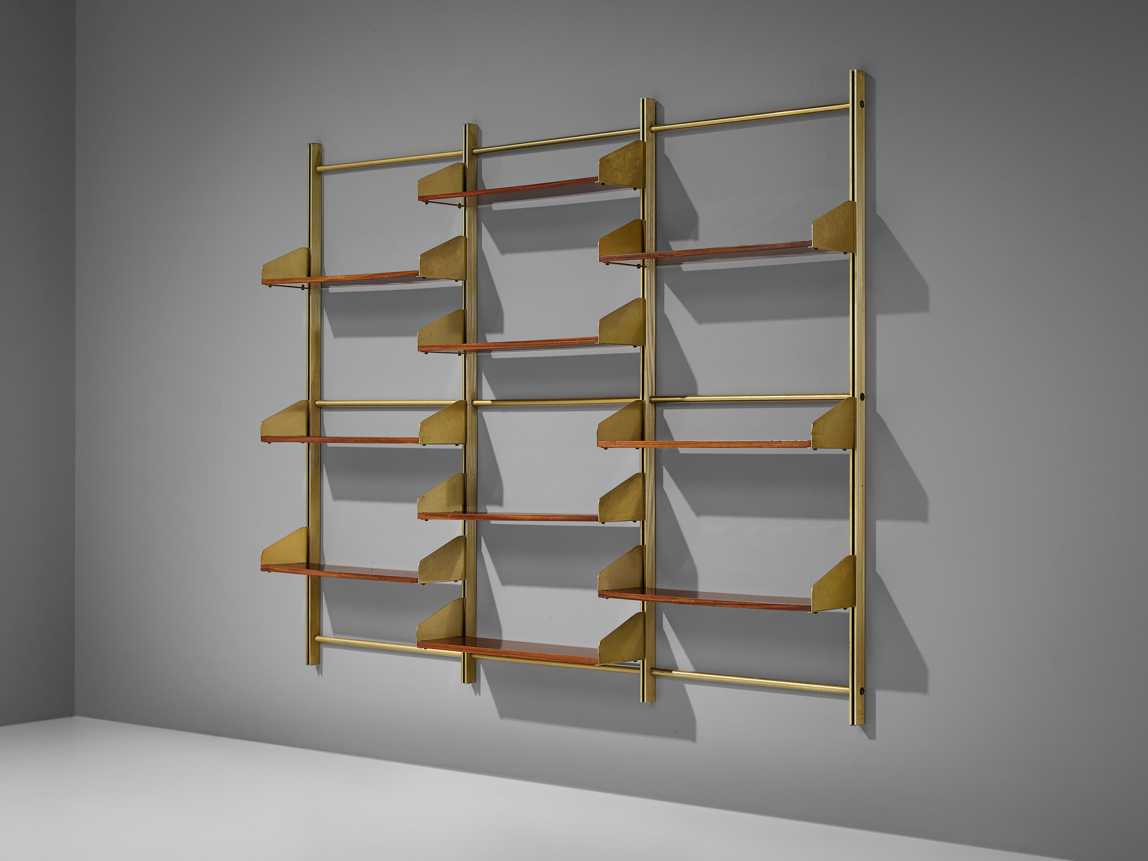 Feal, wall unit, teak, brass, aluminum, Italy, 1950s

This eloquent wall unit by Italian manufacturer Feal is made with a brassed aluminum frame, connective joints and plenty of teak shelves. Three columns structure the shelf vertically. The