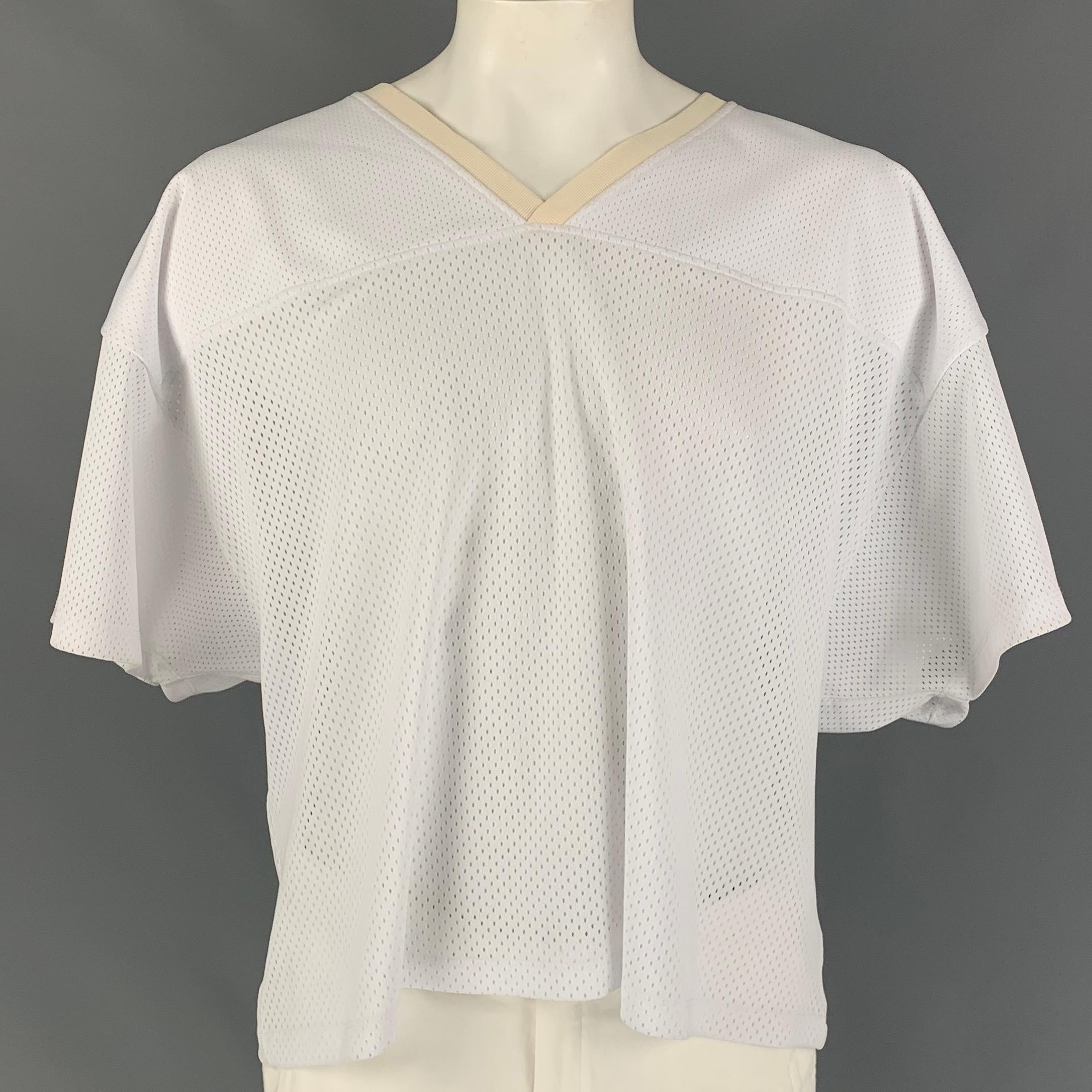 FEAR OF GOD 'MANUEL' Fifth Collection jersey t-shirt comes in a white mesh polyester / silk featuring a oversized fit, back logo detail, and a ribbed v-neck. Made in USA.

Very Good Pre-Owned Condition.
Marked: L/XL

Measurements:

Shoulder: 29